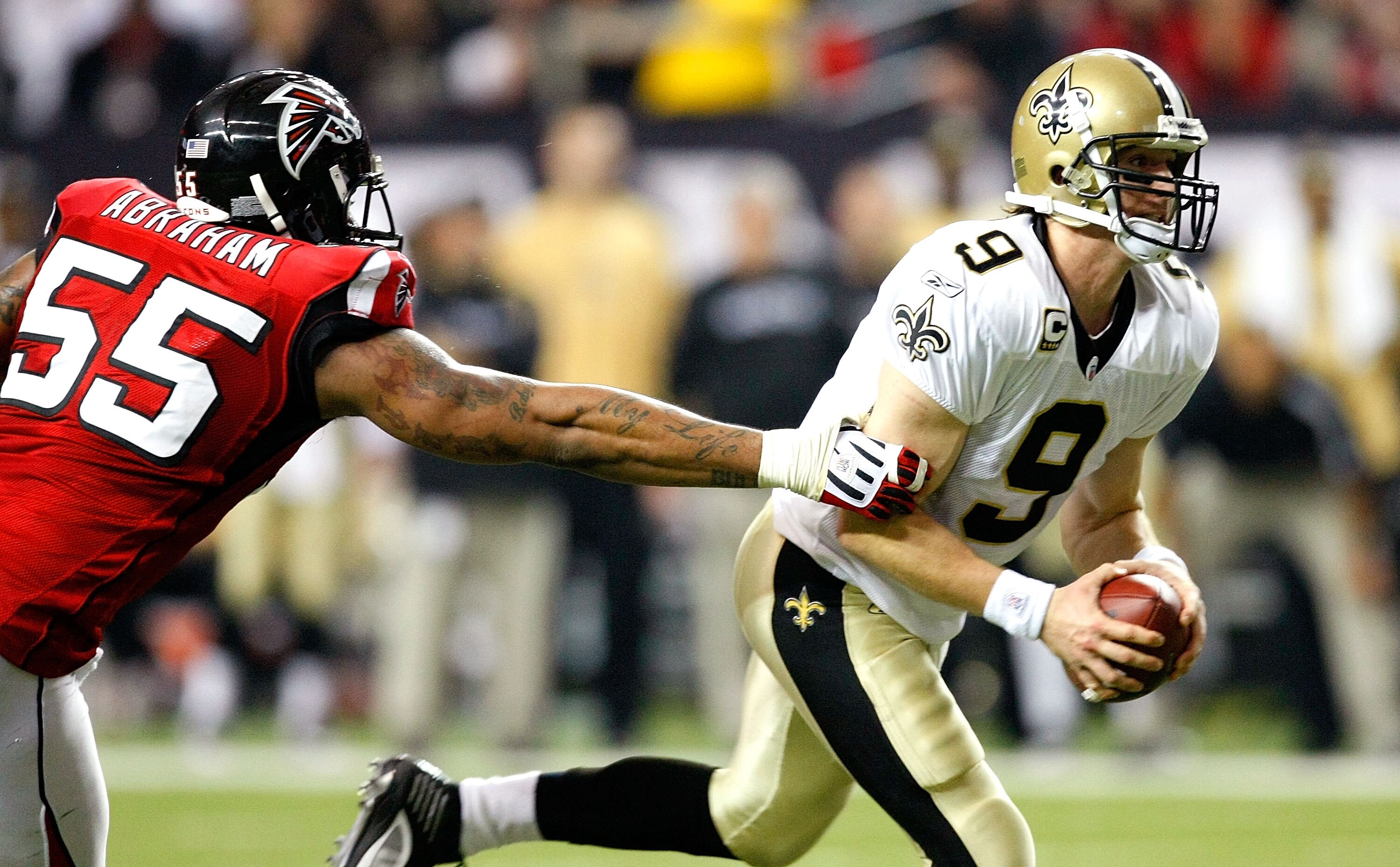 ATLANTA - DECEMBER 13:  John Abraham #55 of the Atlanta Falcons pressures quarterback Drew Brees #9 of the New Orleans Saints at Georgia Dome on December 13, 2009 in Atlanta, Georgia.  (Photo by Kevin C. Cox/Getty Images)