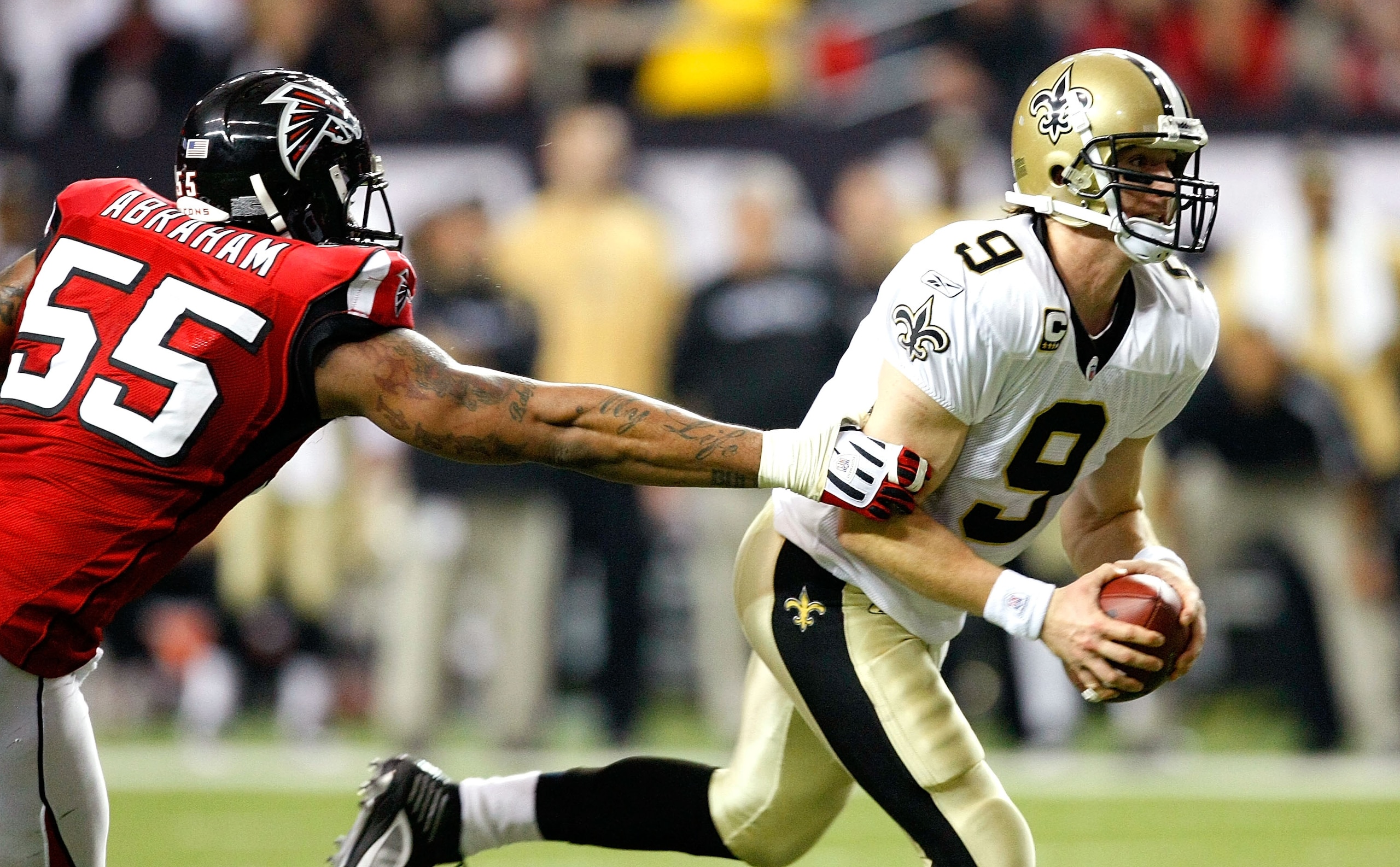 ATLANTA - DECEMBER 13:  John Abraham #55 of the Atlanta Falcons pressures quarterback Drew Brees #9 of the New Orleans Saints at Georgia Dome on December 13, 2009 in Atlanta, Georgia.  (Photo by Kevin C. Cox/Getty Images)