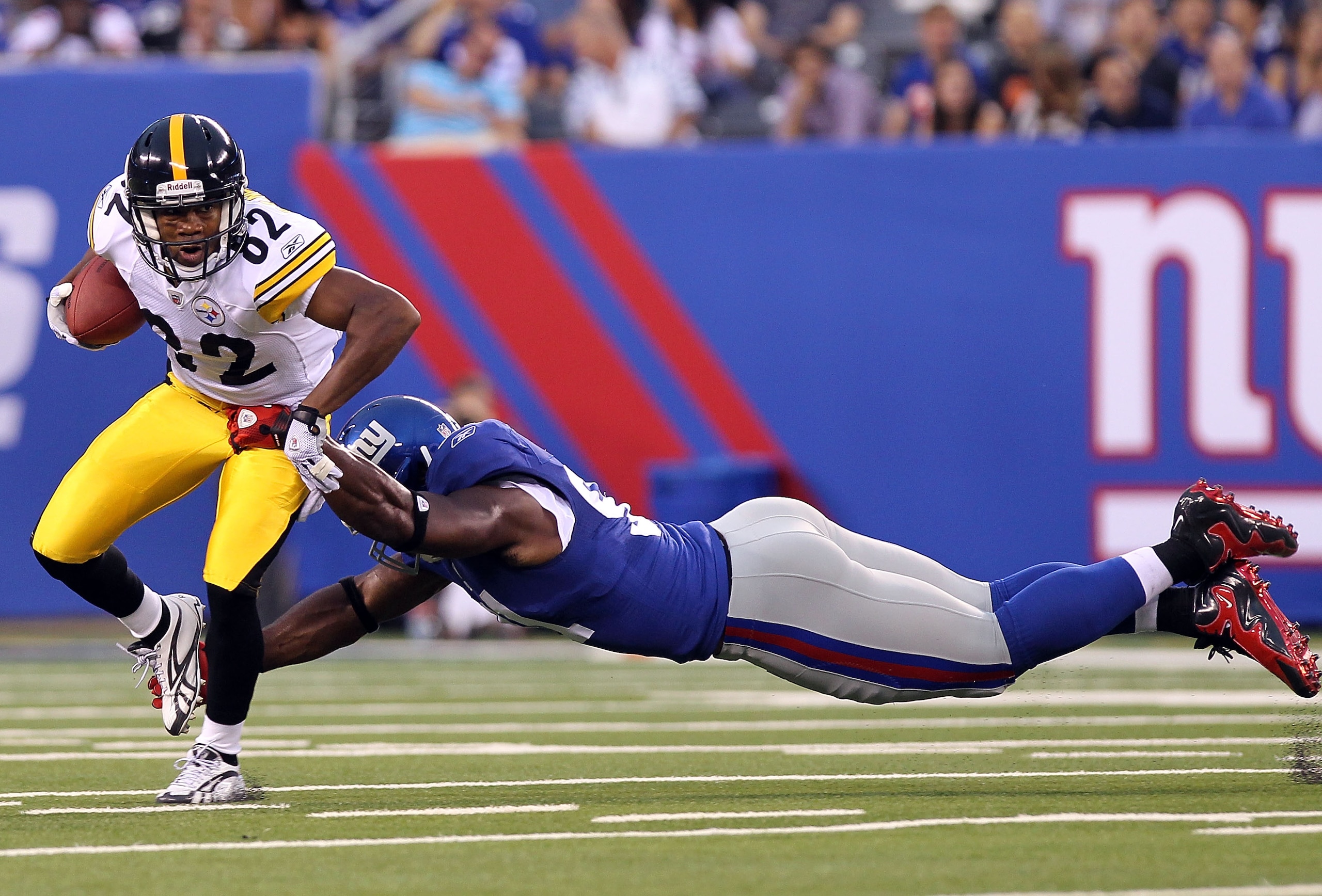 EAST RUTHERFORD, NJ - AUGUST 21: Justin Tuck #91 of the New York Giants tackles Antwaan Randle El #82 of the Pittsburgh Steelers during their preseason game at New Meadowlands Stadium on August 21, 2010 in East Rutherford, New Jersey.  (Photo by Nick Laha