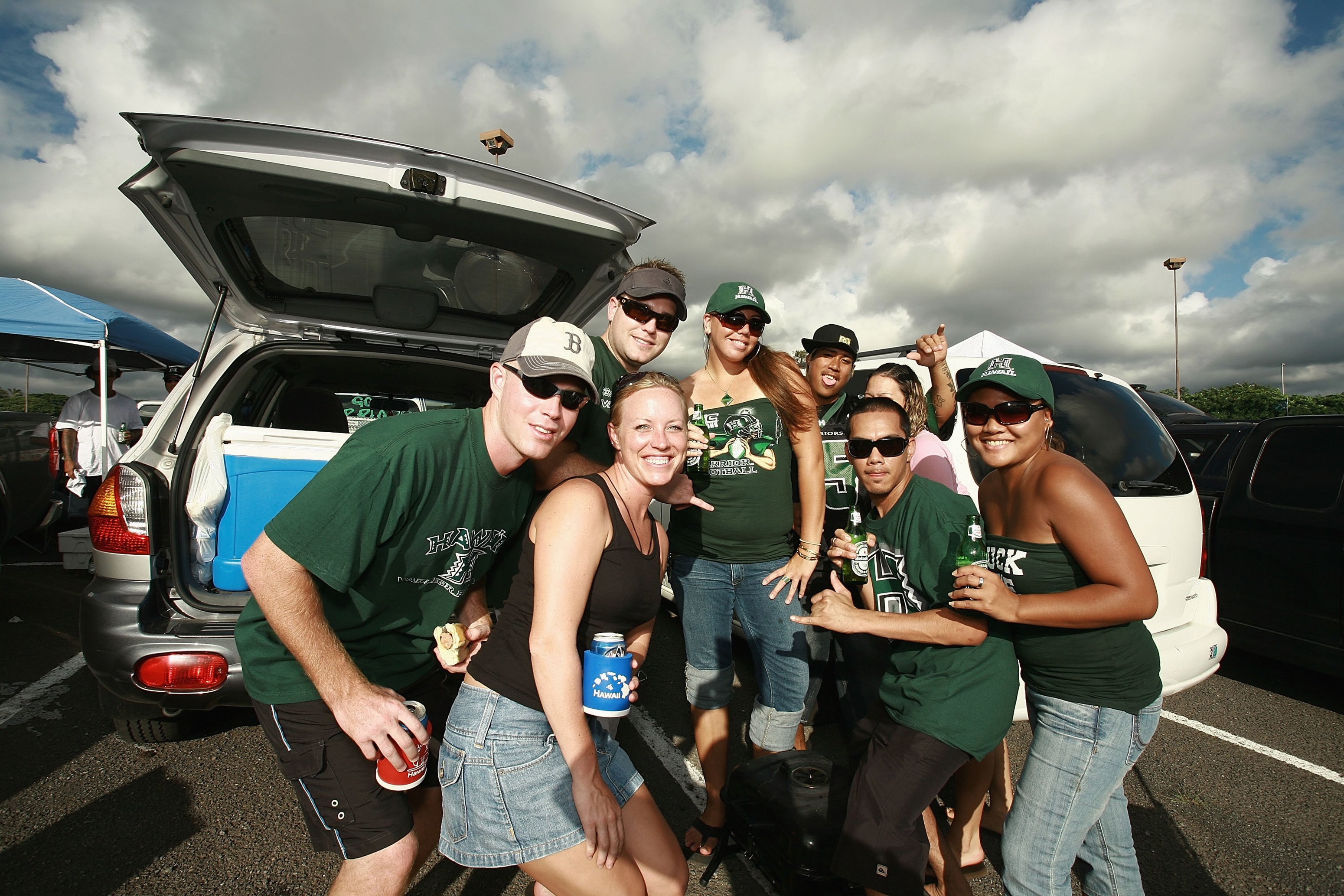 HONOLULU - DECEMBER 2:  Fans of the Hawaii Warriors pose for a photo while tailgating before the game against the Washington Huskies on December 1, 2007 at Aloha Stadium in Honolulu, Hawaii.  Hawaii won 35-28 and finished the season undefeated at 12-0.  (