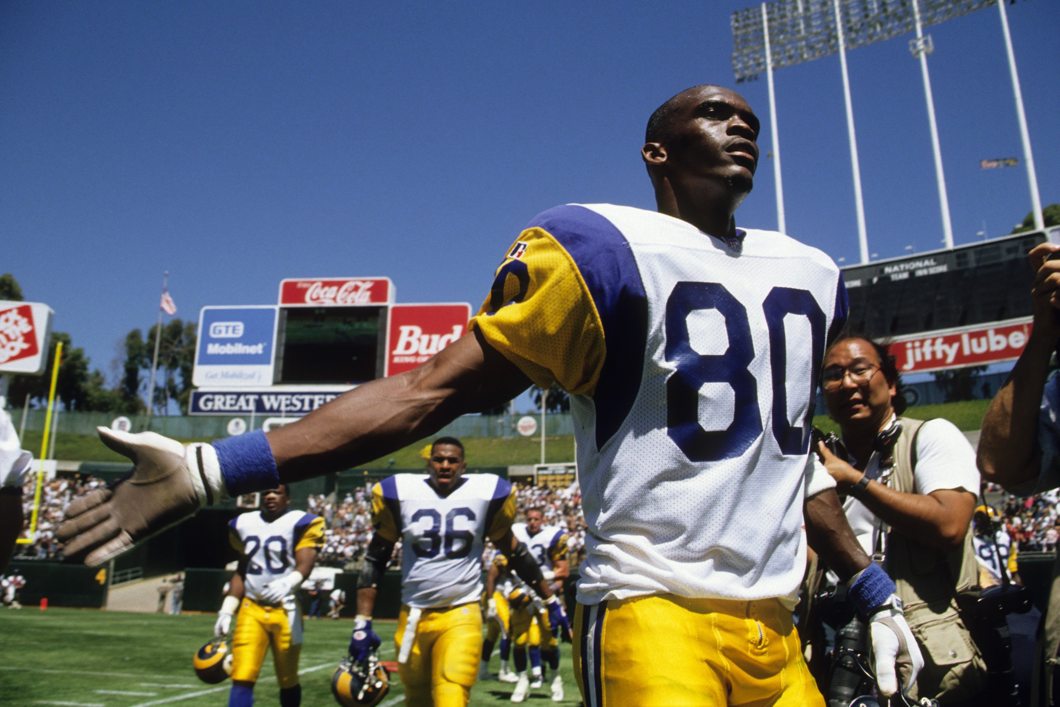 OAKLAND, CA - AUGUST 12:  Wide receiver Isaac Bruce #80 of the Los Angeles Rams enters the field prior to an exhibition game against the Oakland Raiders at at the Oakland/Alameda County Coliseum on August 12, 1995 in Oakland, California. The Raiders won 2