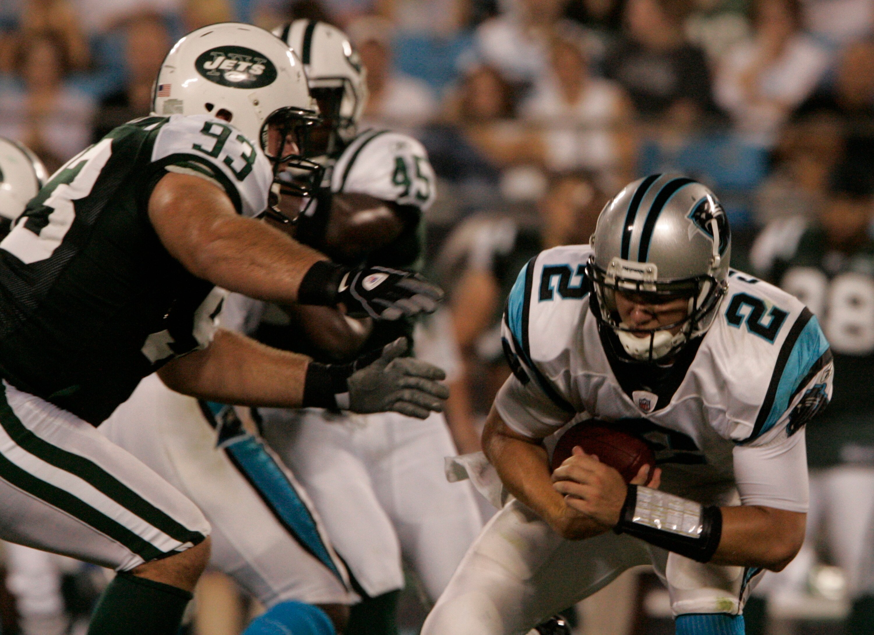 CHARLOTTE, NC - AUGUST 21:  Quarterback Jimmy Clausen #2 of the Carolina Panthers protects the ball as Matt Kroul #93 of the New York Jets attempts a sack during a preseason game at Bank of America Stadium on August 21, 2010 in Charlotte, North Carolina.