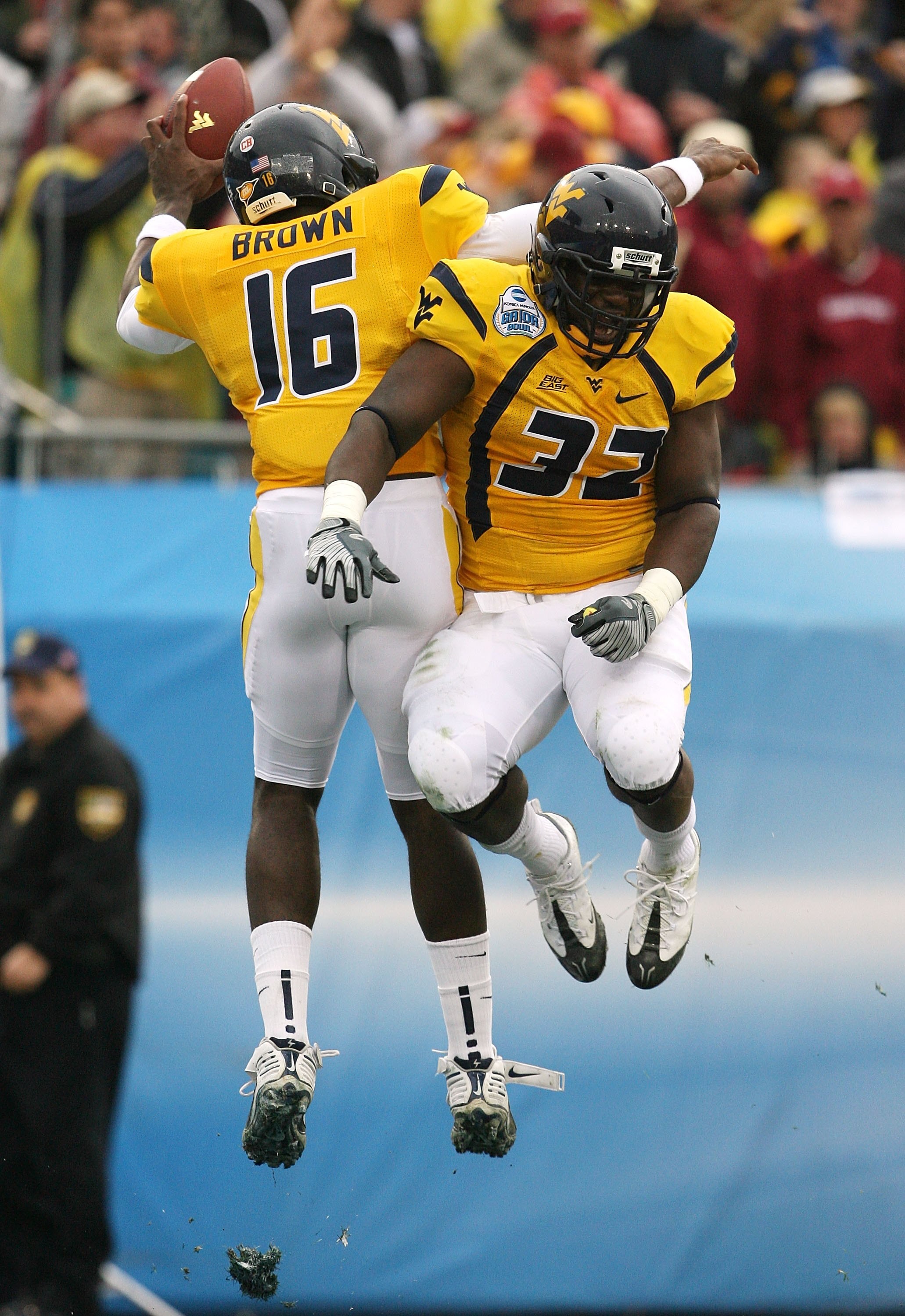 JACKSONVILLE, FL - JANUARY 01:  Running back Ryan Clarke #32 and quarterback Jarrett Brown #16 of the West Virginia Mountaineers celebrate Brown's first quarter touchdown run against the Florida State Seminoles during the Konica Minolta Gator Bowl on Janu