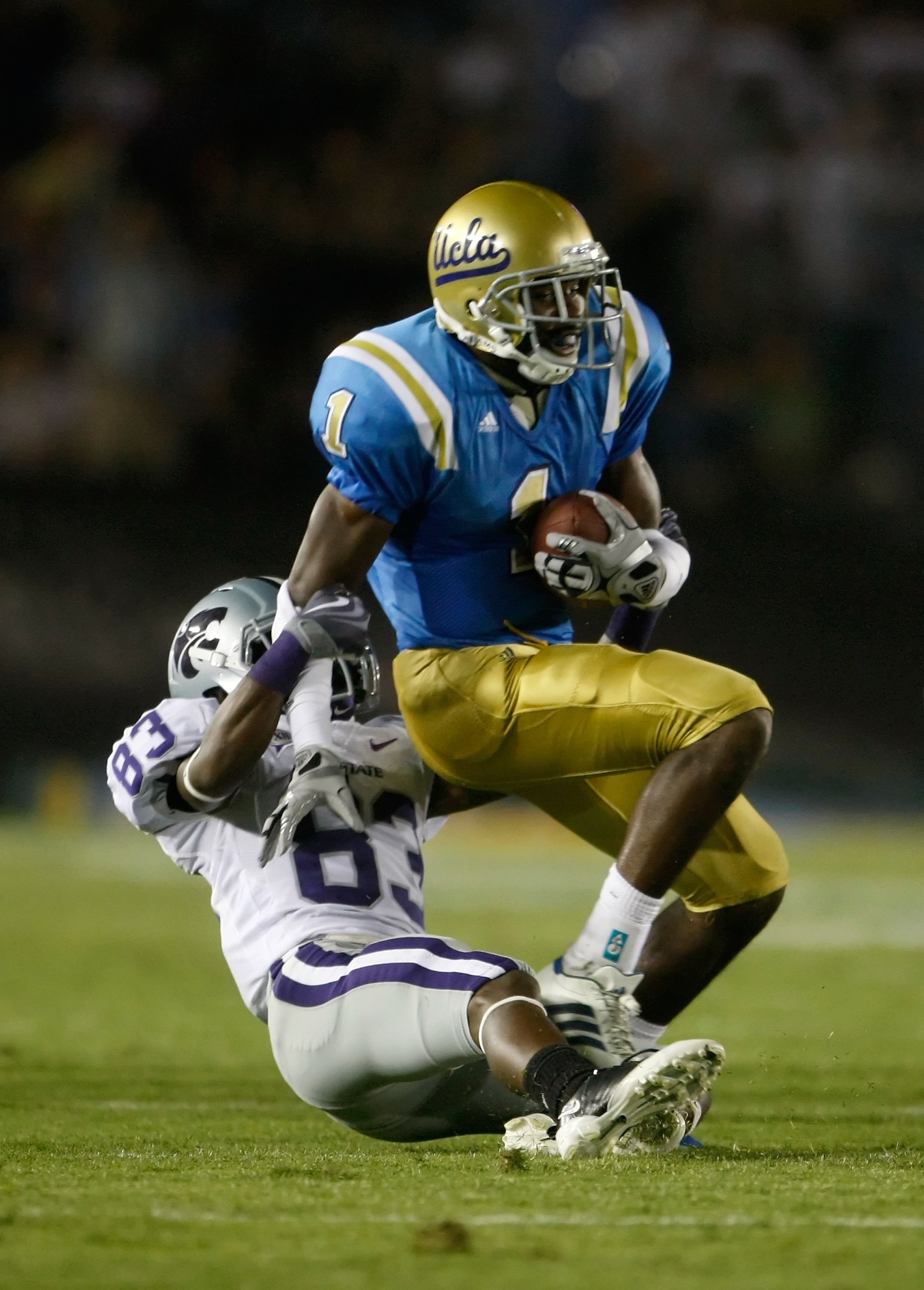 PASADENA, CA - SEPTEMBER 19:  Alterraun Verner #1 of the UCLA Bruins is brought down by Brandon Banks #83 of the Kansas State Wildcats after intercepting a pass in the first half at the Rose Bowl on September 19, 2009 in Pasadena, California. UCLA defeate