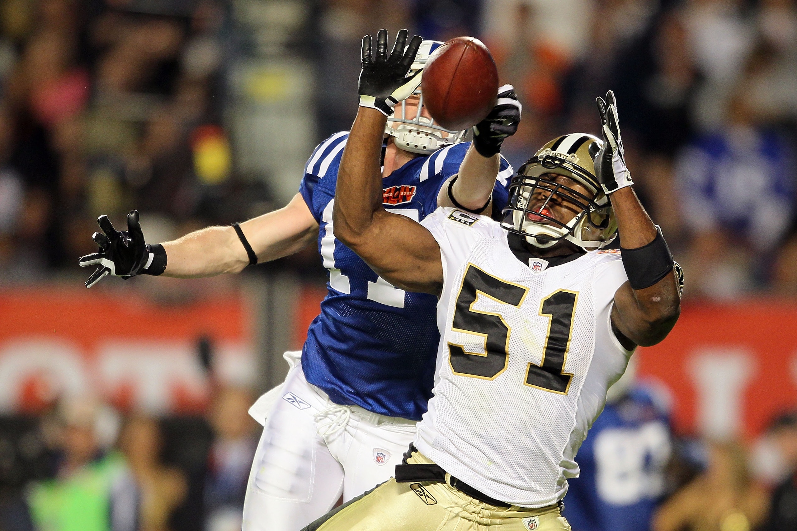MIAMI GARDENS, FL - FEBRUARY 07: Jonathan Vilma #51 of the New Orleans Saints breaks up a pass against Austin Collie #17 of the Indianapolis Colts during Super Bowl XLIV on February 7, 2010 at Sun Life Stadium in Miami Gardens, Florida.  (Photo by Andy Ly