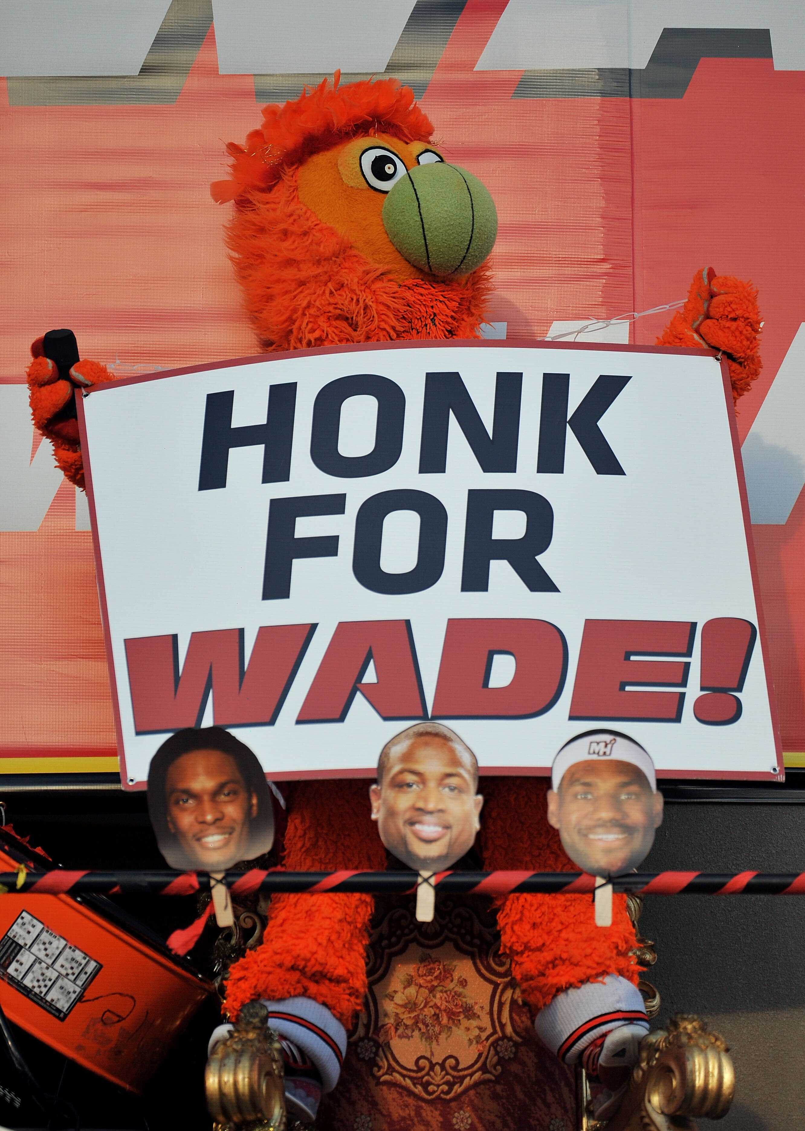 MIAMI - JULY 09: The Miami Heat mascot Burnie stands behind the faces of Chris Bosh #1, Dwyane Wade #3 and LeBron James #6 of the Miami Heat before the start of a welcome party at American Airlines Arena on July 9, 2010 in Miami, Florida.  (Photo by Doug 