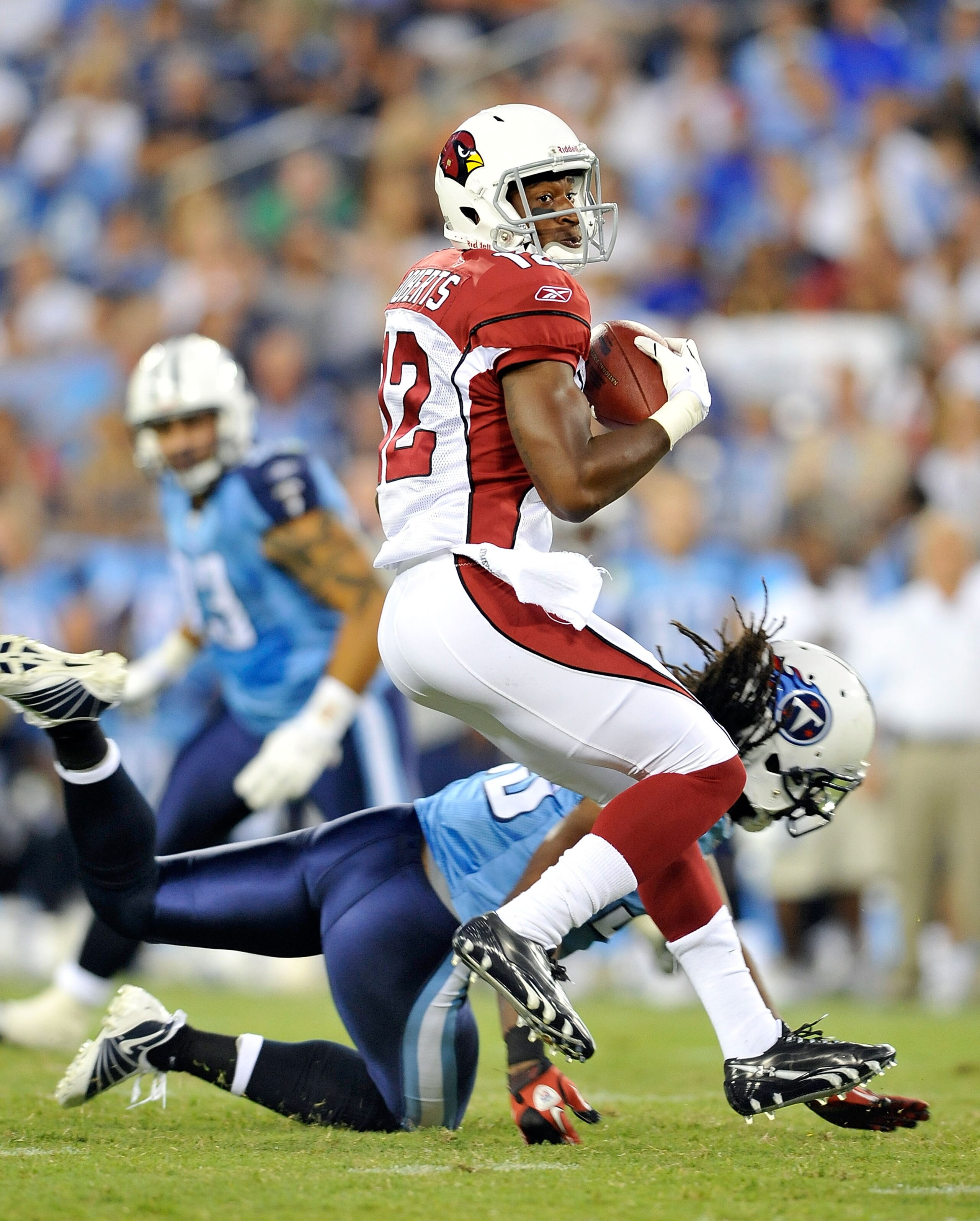 NASHVILLE, TN - AUGUST 23:  Andre Roberts #12 of the Arizona Cardinals spins out of a tackle by Vincent Fuller #22 of the Tennessee Titans during the first half of a preseason game at LP Field on August 23, 2010 in Nashville, Tennessee.  (Photo by Grant H