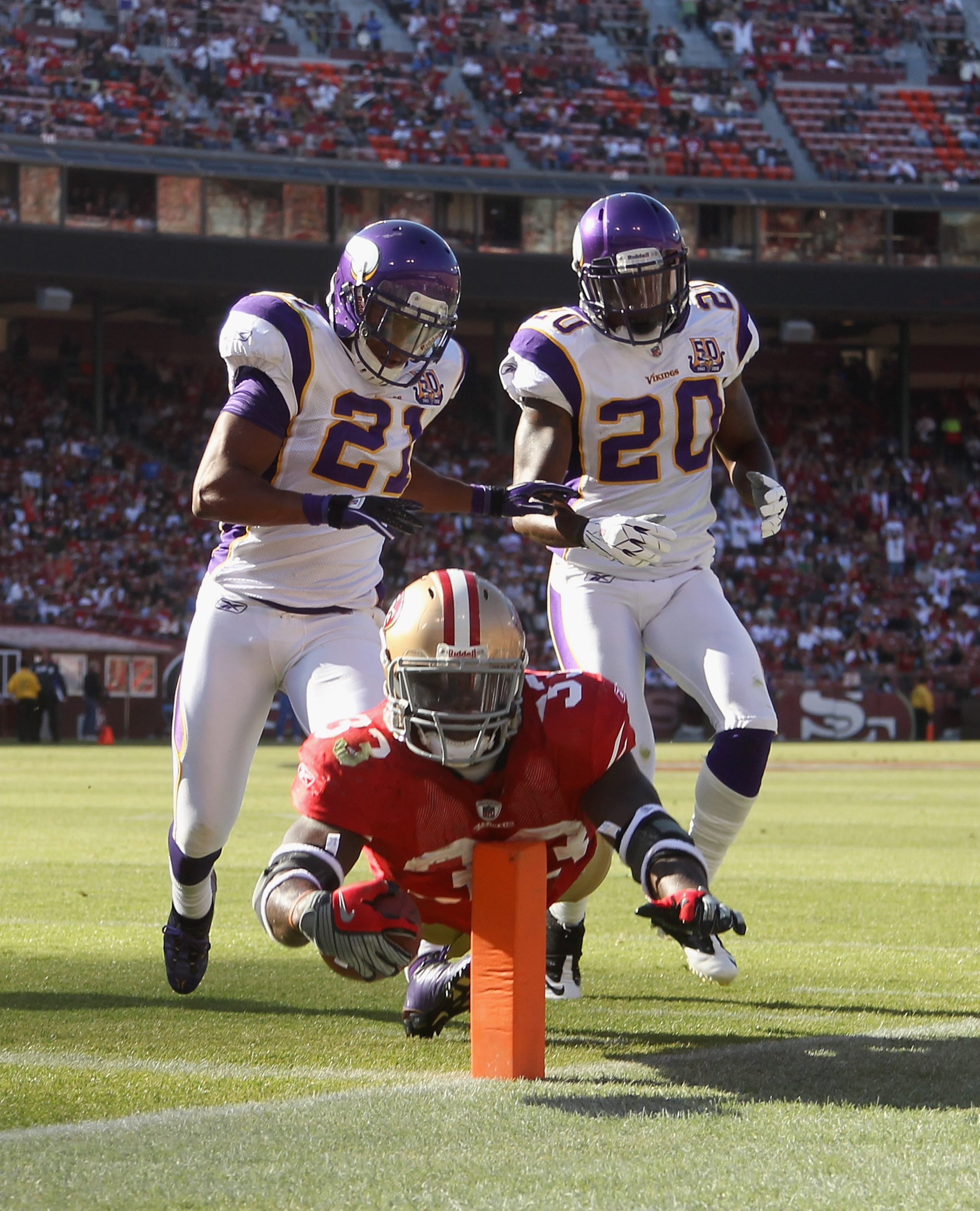 SAN FRANCISCO - AUGUST 22: Anthony Dixon #33 of the San Francisco 49ers dives past Madieu Williams #20 and Asher Allen #21 of the Minnesota Vikings at Candlestick Park on August 22, 2010 in San Francisco, California. (Photo by Ezra Shaw/Getty Images) SAN FRANCISCO - AUGUST 22: Anthony Dixon #33 of the San Francisco 49ers dives past Madieu Williams #20 and Asher Allen #21 of the Minnesota Vikings at Candlestick Park on August 22, 2010 in San Francisco, California. (Photo by Ezra Shaw/Getty Images)