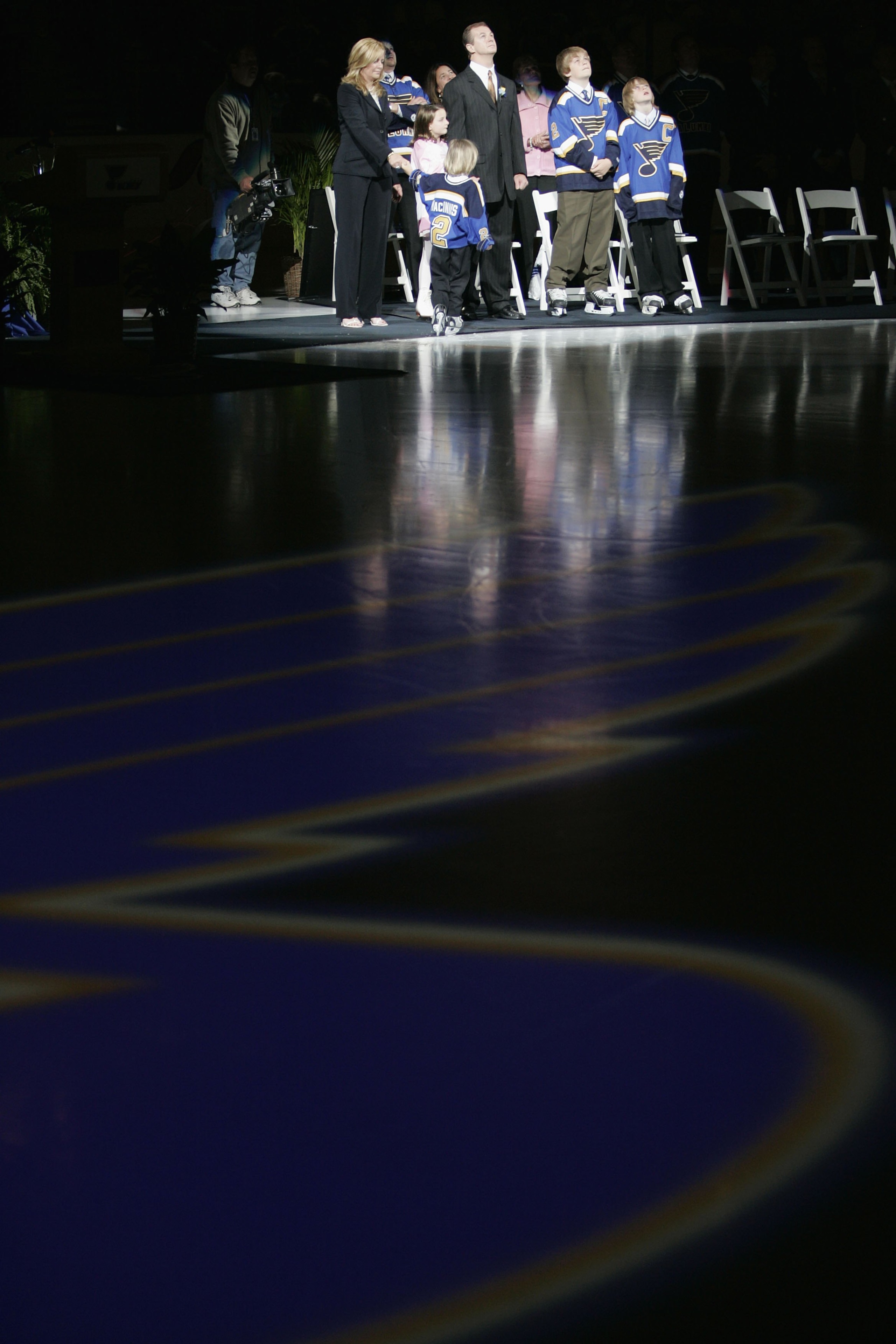 ST. LOUIS - APRIL 9:  Former St. Louis Blues defenseman Al MacInnis #2 and his family watch his banner being raised during his jersey retirement ceremony prior to the game between the Blues and Edmonton Oilers at the Savvis Center on April 9, 2006 in St.