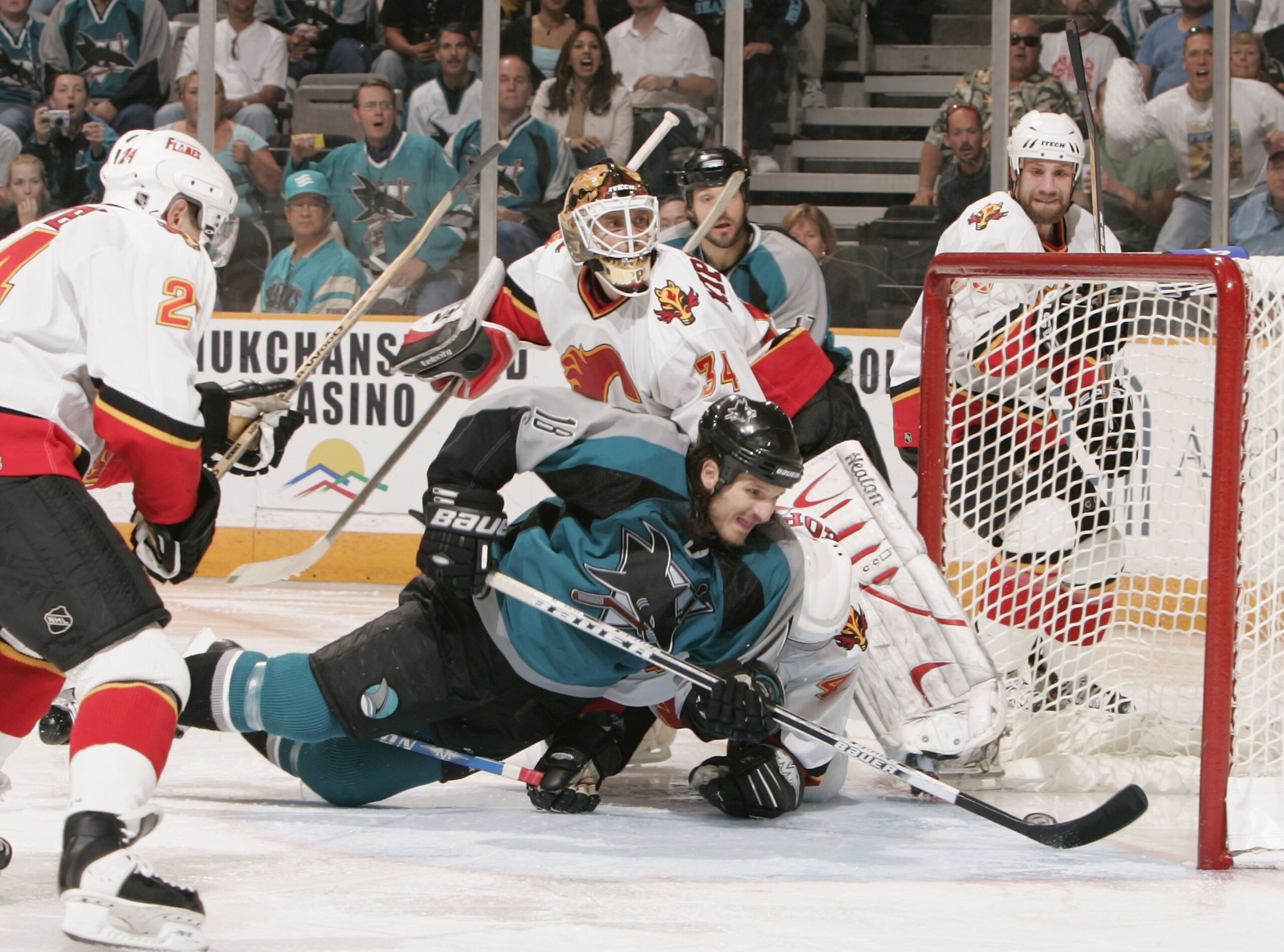 SAN JOSE, CA - MAY 9:  Mike Ricci #18 of the San Jose Sharks scores against Miikka Kiprusoff #34 of Calgary Flames during Game one of the 2004 NHL Western Conference Finals during the Stanley Cup Playoffs on May 9, 2004 at the HP Pavilion at San Jose in S