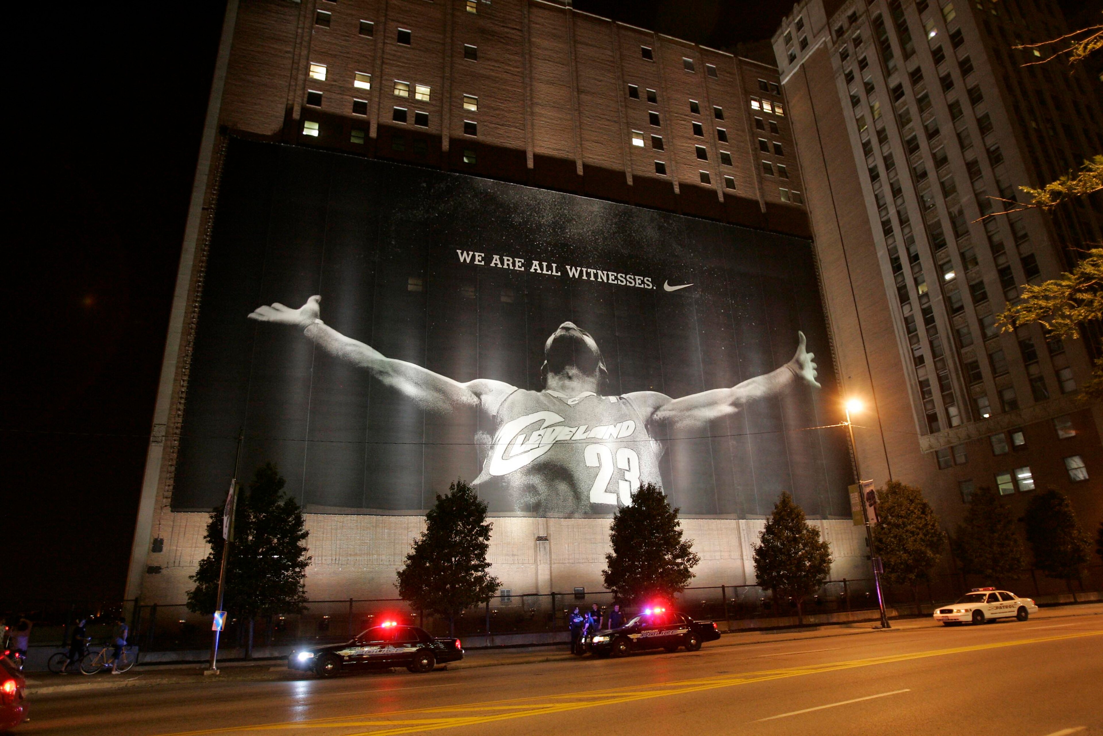 CLEVELAND - JULY 8: Police stand guard near a larger than life photograph of LeBron James after the announcement that James will play next season for the Miami Heat July 8, 2010 in Cleveland, Ohio. The two-time Most Valuable Player made the choice to pla CLEVELAND - JULY 8: Police stand guard near a larger than life photograph of LeBron James after the announcement that James will play next season for the Miami Heat July 8, 2010 in Cleveland, Ohio. The two-time Most Valuable Player made the choice to pla