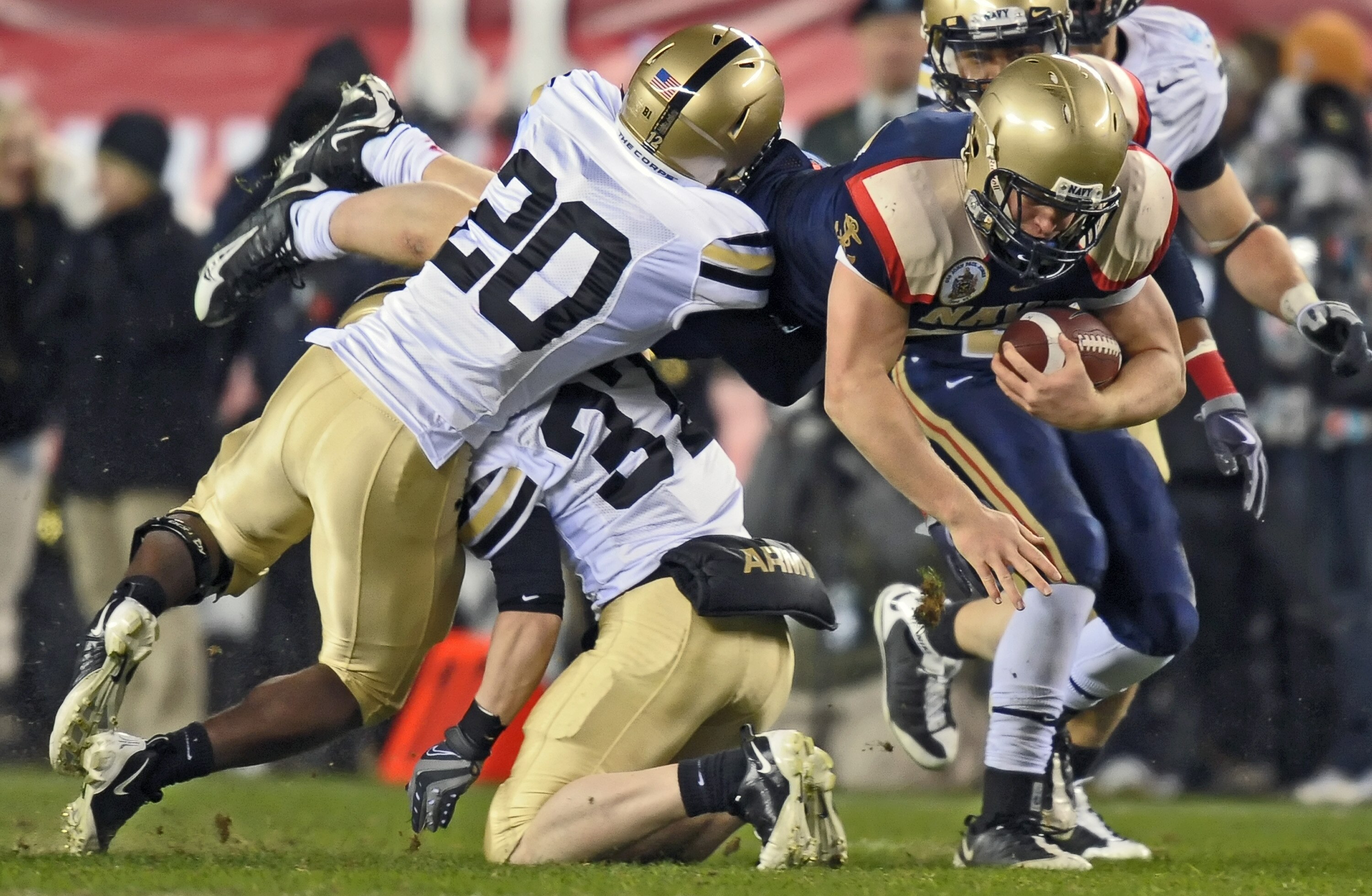 PHILADELPHIA - DECEMBER 12: Fullback Vince Murray #47 of the Navy Midshipmen gets upended by defensive backs Ty Shrader #37 and Jordan Trimble #20 of the Army Black Knights on December 12, 2009 at Lincoln Financial Field in Philadelphia, Pennsylvania. Nav
