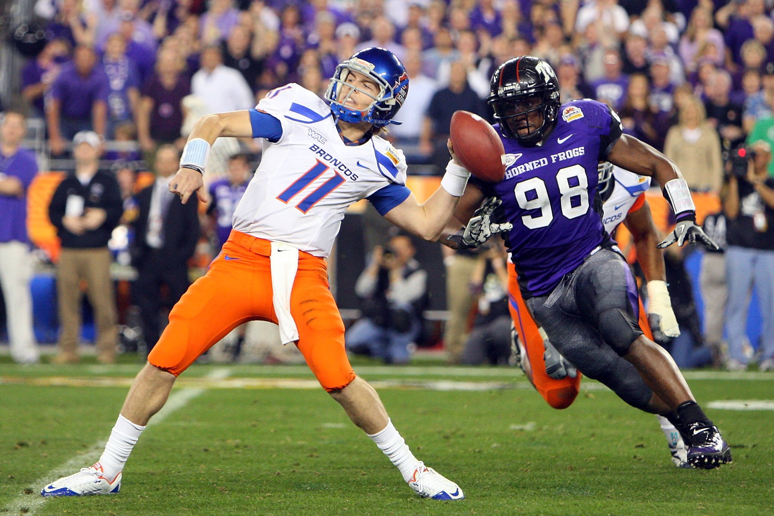 GLENDALE, AZ - JANUARY 04:  Quarterback Kellen Moore #11 of the Boise State Broncos passes the ball in the second half as Jerry Hughes #98 of the TCU Horned Frogs rushes in during the Tostitos Fiesta Bowl at the Universtity of Phoenix Stadium on January 4