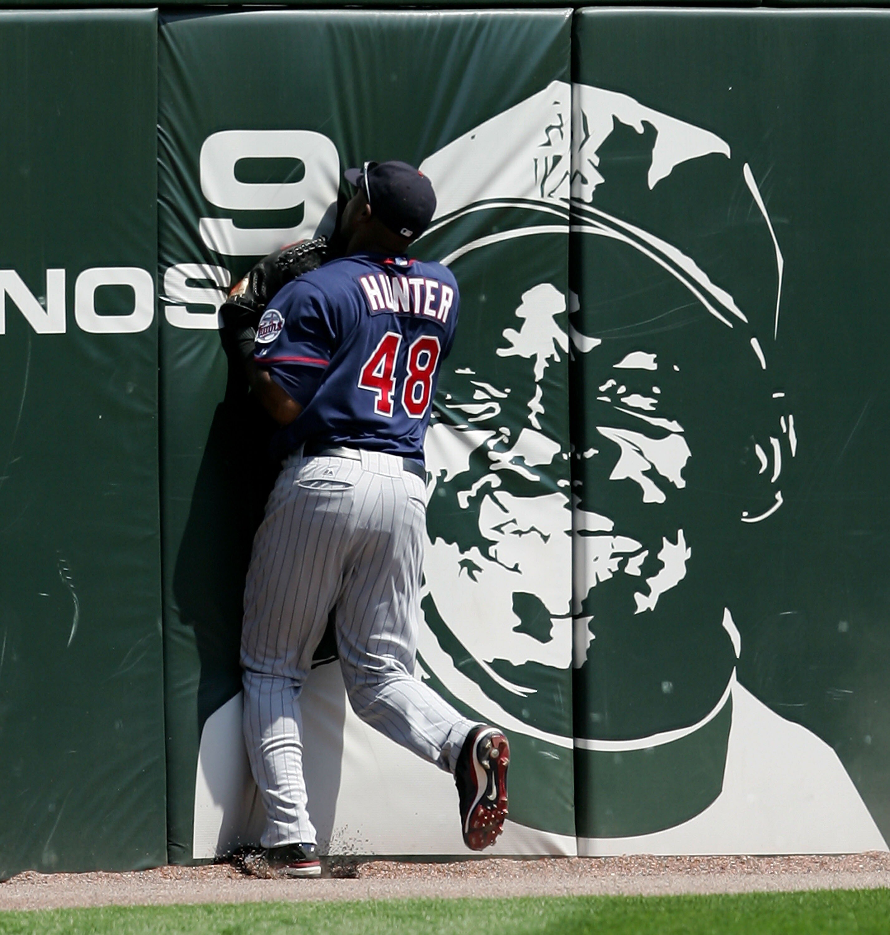 CHICAGO - JULY 08: Torii Hunter #48 of the Minnesota Twins hits the outfield wall after making a catch on a ball hit by A.J. Pierzynski of the Chicago White Sox on July 8, 2007 at U.S. Cellular Field in Chicago, Illinois. The White Sox defeated the Twins 