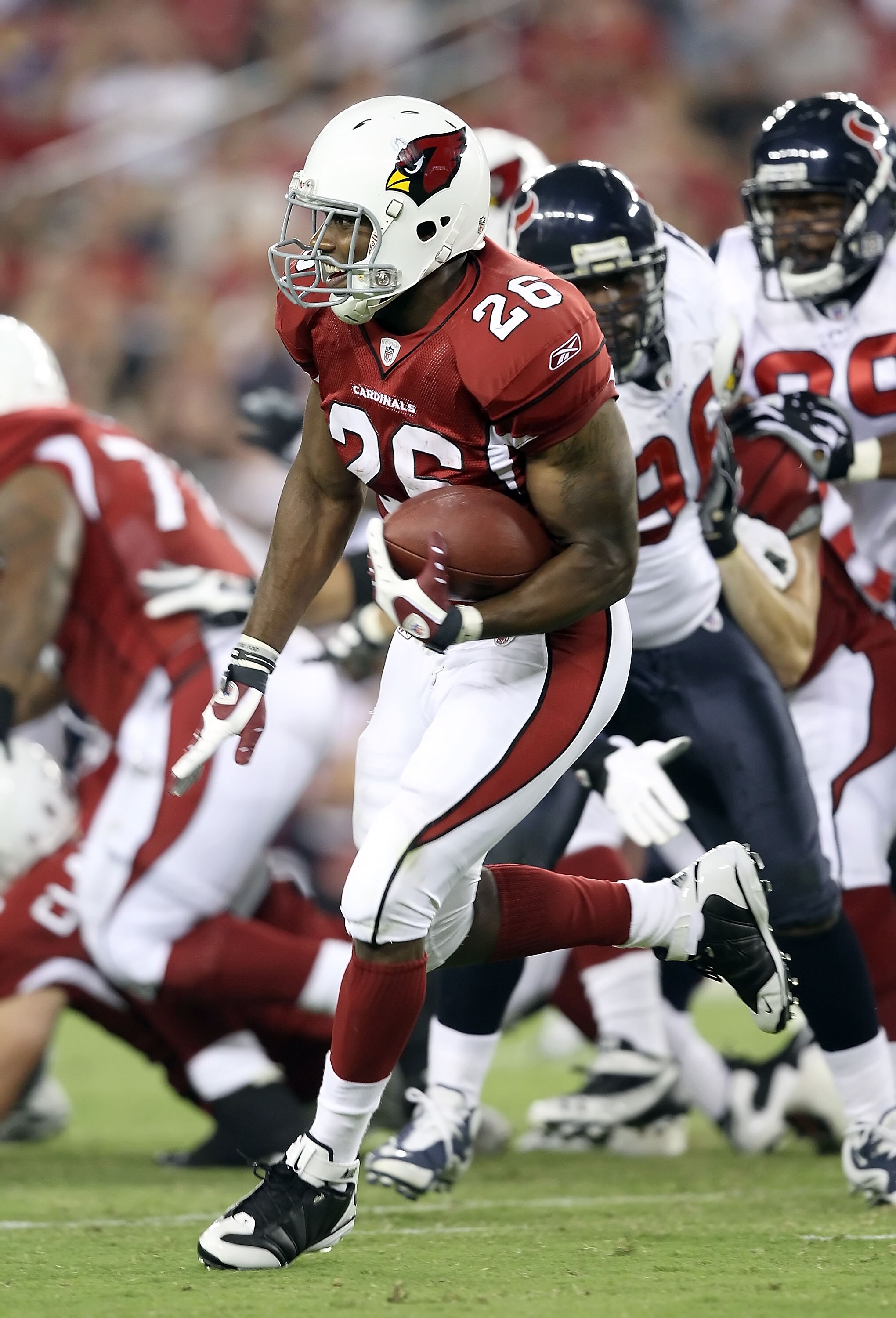 GLENDALE, AZ - AUGUST 14:  Runningback Beanie Wells #26 of the Arizona Cardinals rushes the ball against the Houston Texans during preseason NFL game at the University of Phoenix Stadium on August 14, 2010 in Glendale, Arizona.  The Cardinals defeated the