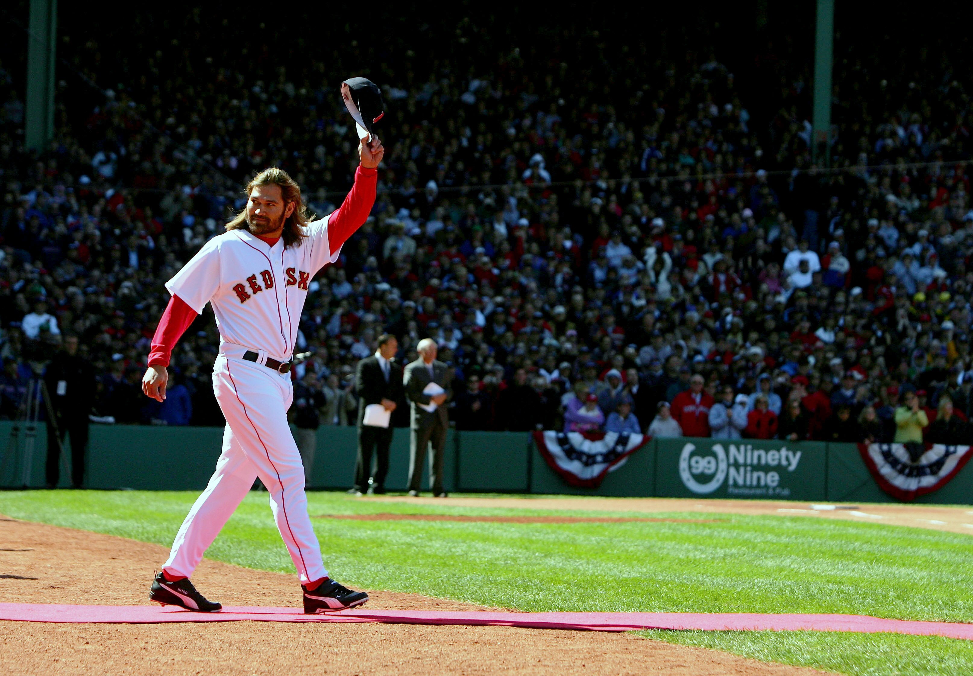 BOSTON - APRIL 11:  Johnny Damon #18 of the Boston Red Sox waves to the crowd as he goes out to receive his 2004 World Series Championship ring before their game against the New York Yankees at Fenway Park on April 11, 2005 in Boston, Massachusetts.  (Pho