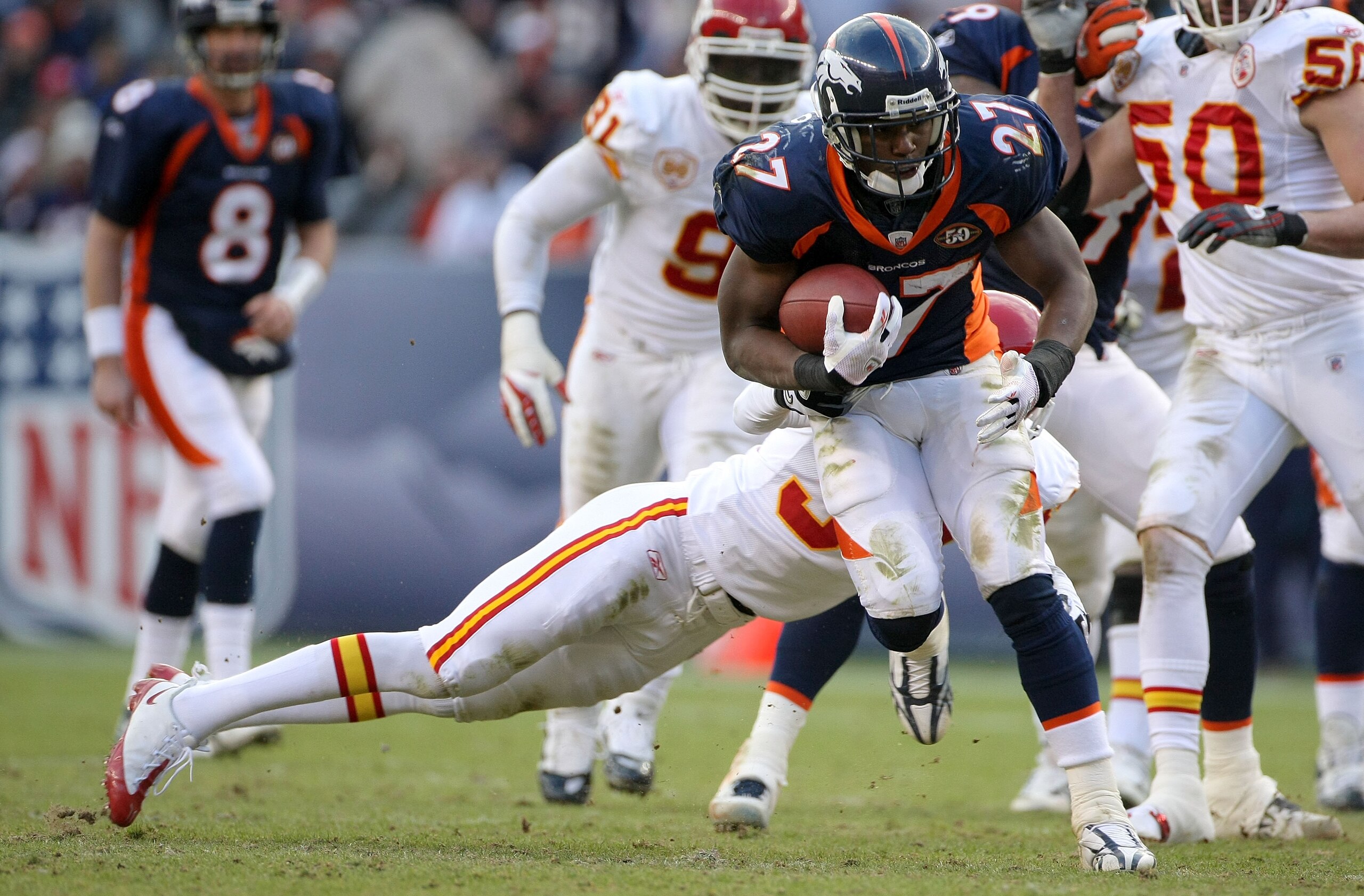 DENVER - JANUARY 03: Running back Knowshon Moreno #27 of the Denver Broncos rushes for yardage as Travis Daniels #34 of the Kansas City Chiefs makes the tackle during NFL action at Invesco Field at Mile High on January 3, 2010 in Denver, Colorado. (Photo DENVER - JANUARY 03: Running back Knowshon Moreno #27 of the Denver Broncos rushes for yardage as Travis Daniels #34 of the Kansas City Chiefs makes the tackle during NFL action at Invesco Field at Mile High on January 3, 2010 in Denver, Colorado. (Photo