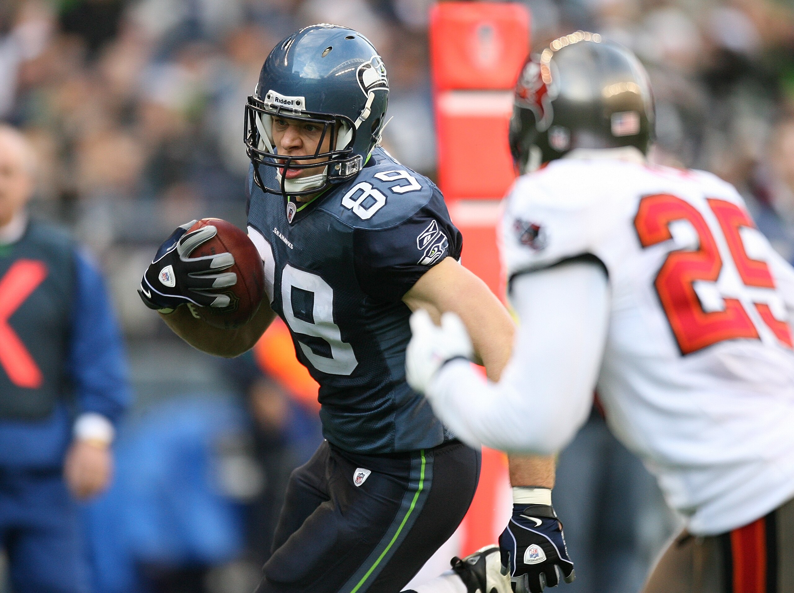 SEATTLE - DECEMBER 20:  Tight end John Carlson #89 of the Seattle Seahawks scores a touchdown against Aqib Talib #25 of the Tampa Bay Buccaneers on December 20, 2009 at Qwest Field in Seattle, Washington.  (Photo by Otto Greule Jr/Getty Images)