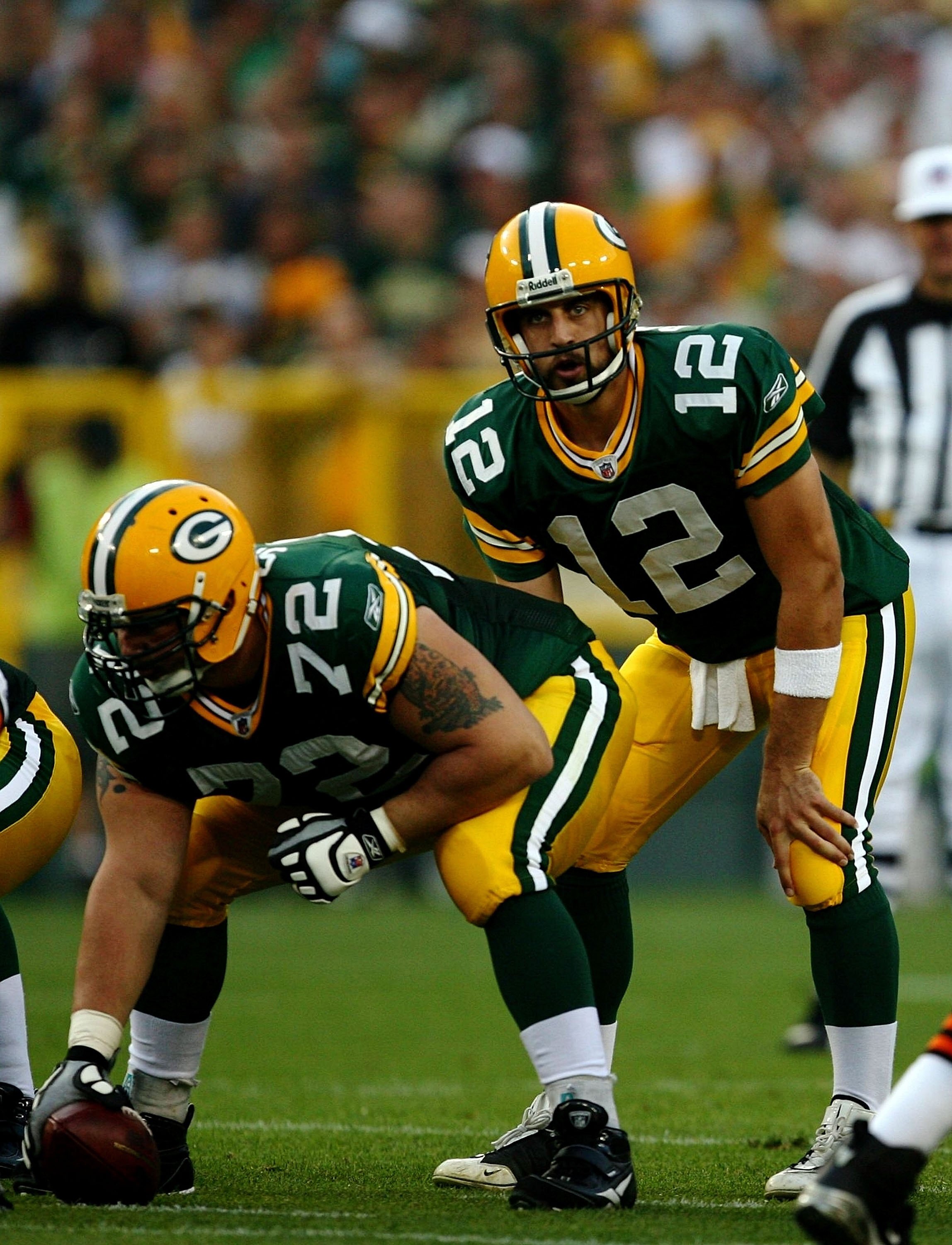 GREEN BAY, WI - AUGUST 15:  Quarterback Aaron Rodgers #12 of the Green Bay Packers waits for the snap behind center Jason Spitz #72 against the Cleveland Browns during the preseason game at Lambeau Field on August 15, 2009 in Green Bay, Wisconsin.  (Photo