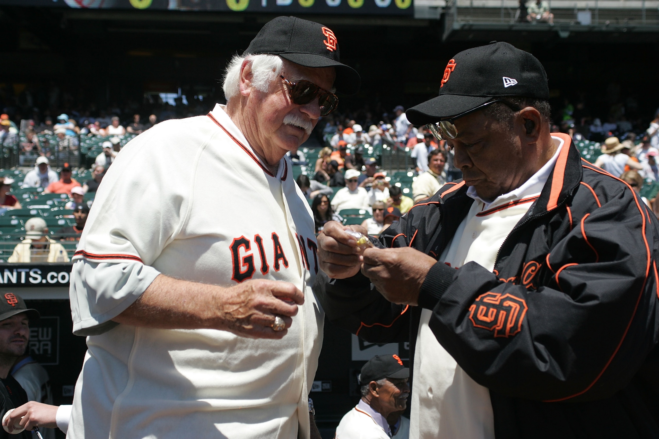 SAN FRANCISCO - JUNE 24:  Hall of Fame San Francisco Giants Gaylord Perry (L) and Willie Mays admire a pin commemorating the 1962 World series between the Giants and the New York Yankees before the San Francisco Giants 7-2 defeat of the New York Yankees a