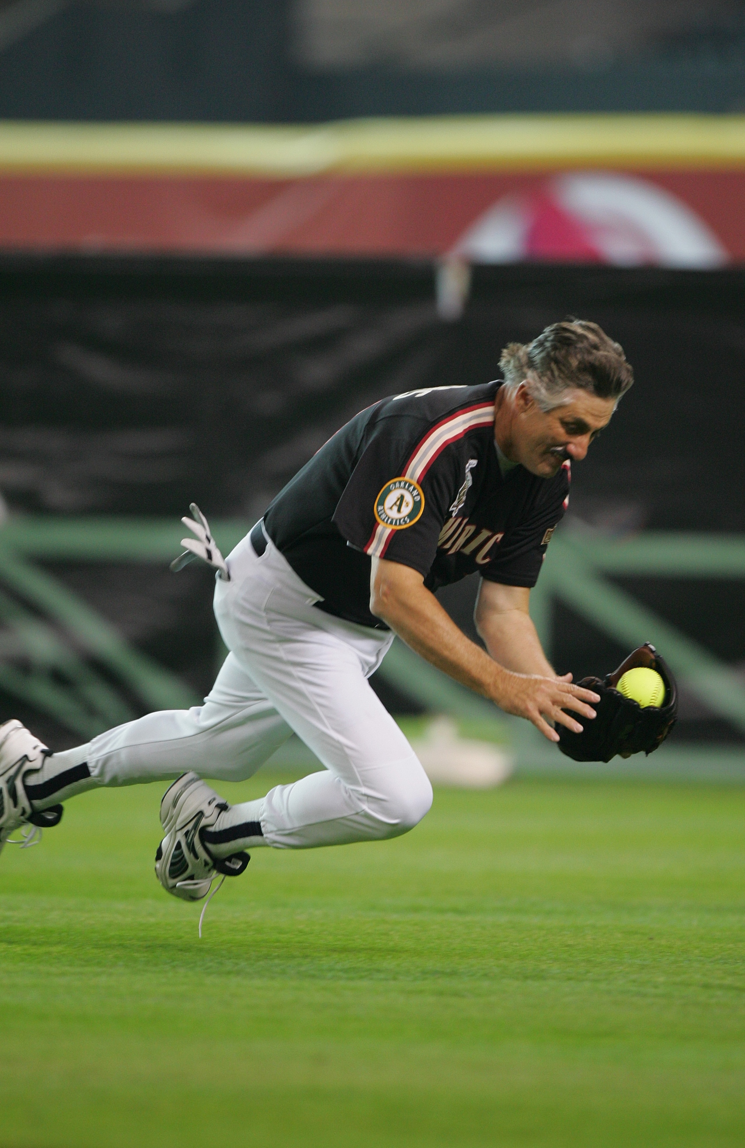 HOUSTON - JULY 11:  Rollie Fingers, Hall of Fame pitcher who played with the Oakland A's and San Diego Padres catches a fly ball during the Major League Baseball Legends and Celebrity Softball Game at Minute Maid Park on July 11, 2004 in Houston, Texas. (