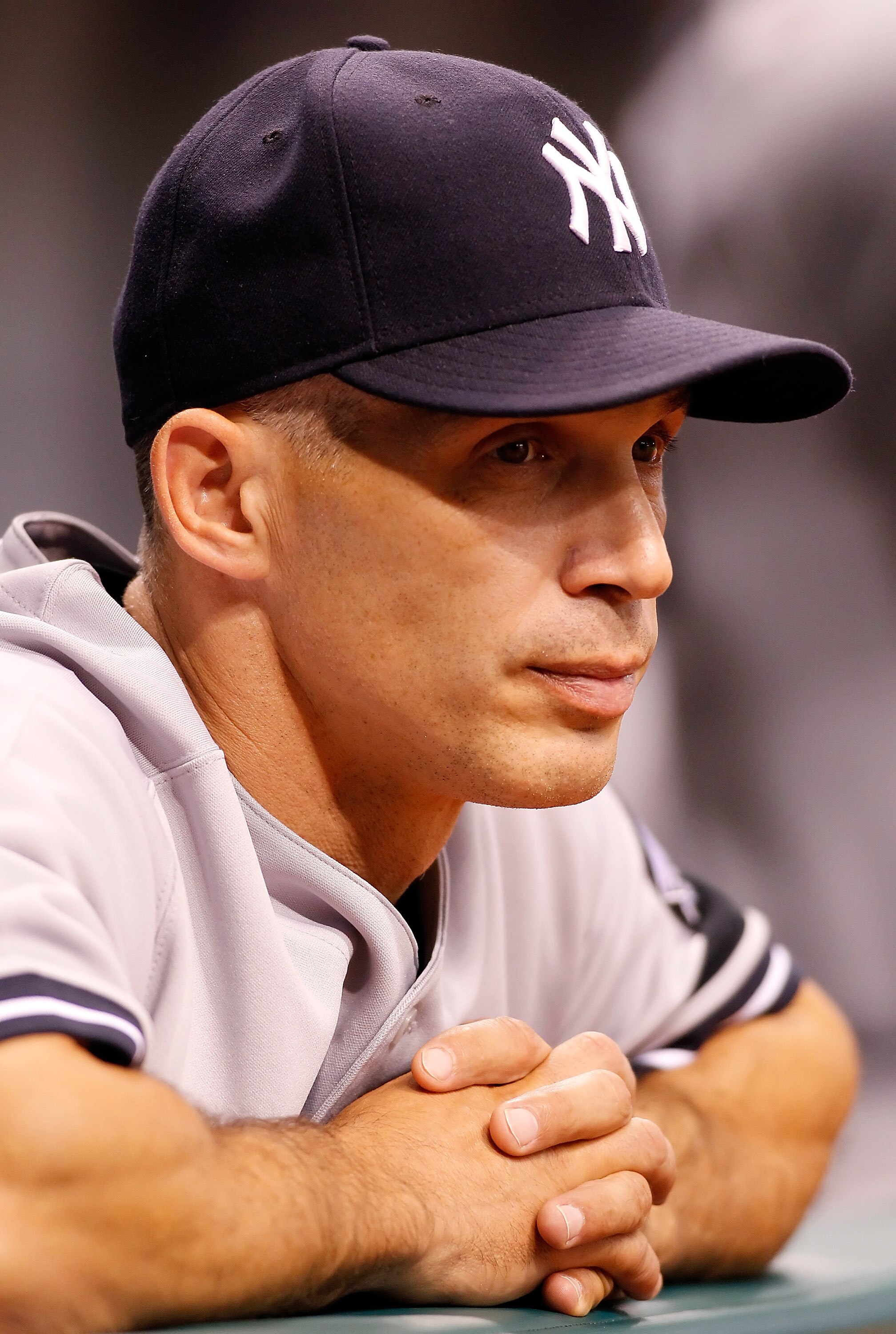 ST. PETERSBURG - JULY 30:  Manager Joe Girardi #28 of the New York Yankees watches his team from the dugout against the Tampa Bay Rays during the game at Tropicana Field on July 30, 2010 in St. Petersburg, Florida.  (Photo by J. Meric/Getty Images)