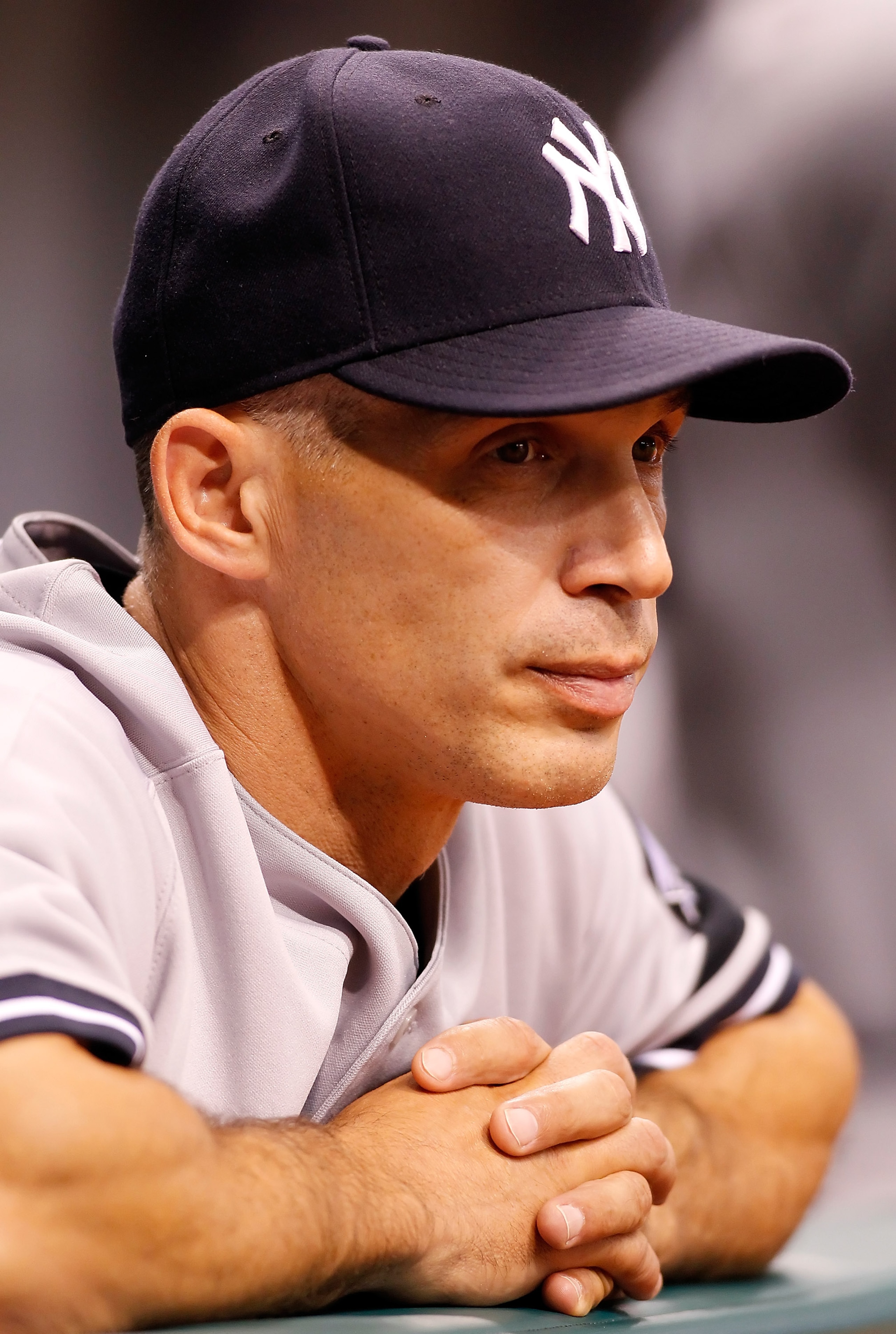 ST. PETERSBURG - JULY 30:  Manager Joe Girardi #28 of the New York Yankees watches his team from the dugout against the Tampa Bay Rays during the game at Tropicana Field on July 30, 2010 in St. Petersburg, Florida.  (Photo by J. Meric/Getty Images)