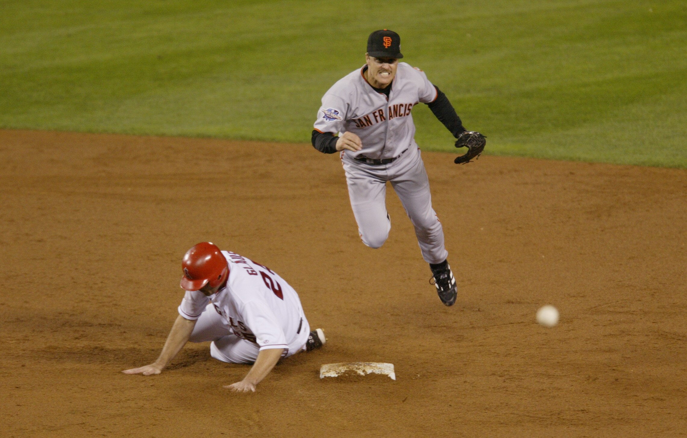 ANAHEIM, CA - OCTOBER 27:  Jeff Kent #21 of the San Francisco Giants drills the ball to first for a double play over Scott Spiezio #23 of the Anaheim Angels during the third inning of game seven during the World Series at Edison Field in Anaheim, Californ