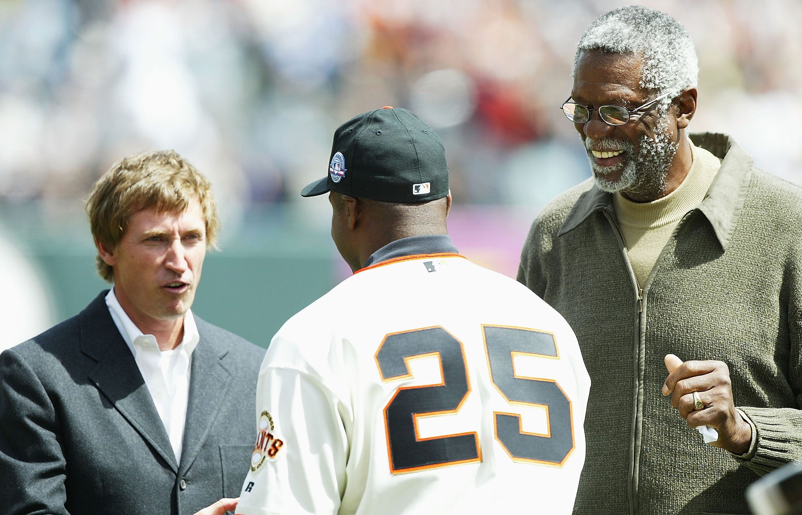 SAN FRANCISCO - APRIL 12:  Barry Bonds #25 of the San Francisco Giants accepts the 2003 MVP Trophy from Wayne Gretzky and Bill Russell before his game against the Milwaukee Brewers on April 12, 2004 at SBC Park in San Francsico, California.  (Photo by Jed