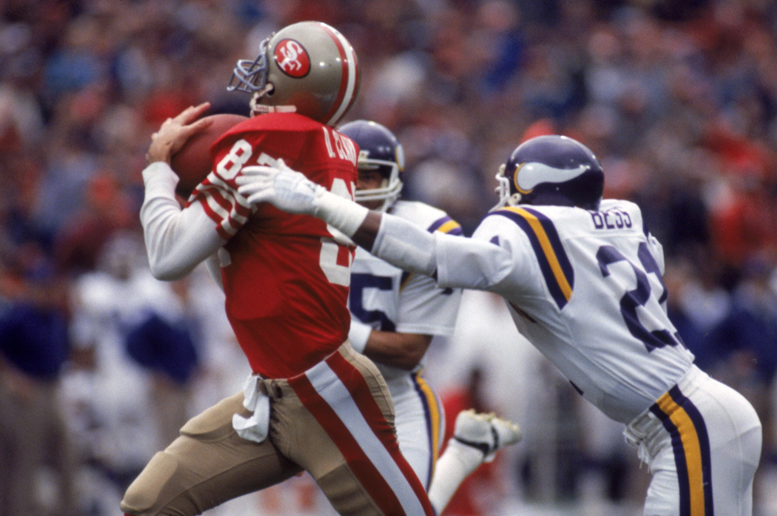 SAN FRANCISCO - DECEMBER 8:  Wide receiver Dwight Clark #87 of the San Francisco 49ers catches a pass against defensive back Rufus Bess #21 of the Minnesota Vikings during a game at Candlestick Park on December 8, 1984 in San Francisco, California.  The 4