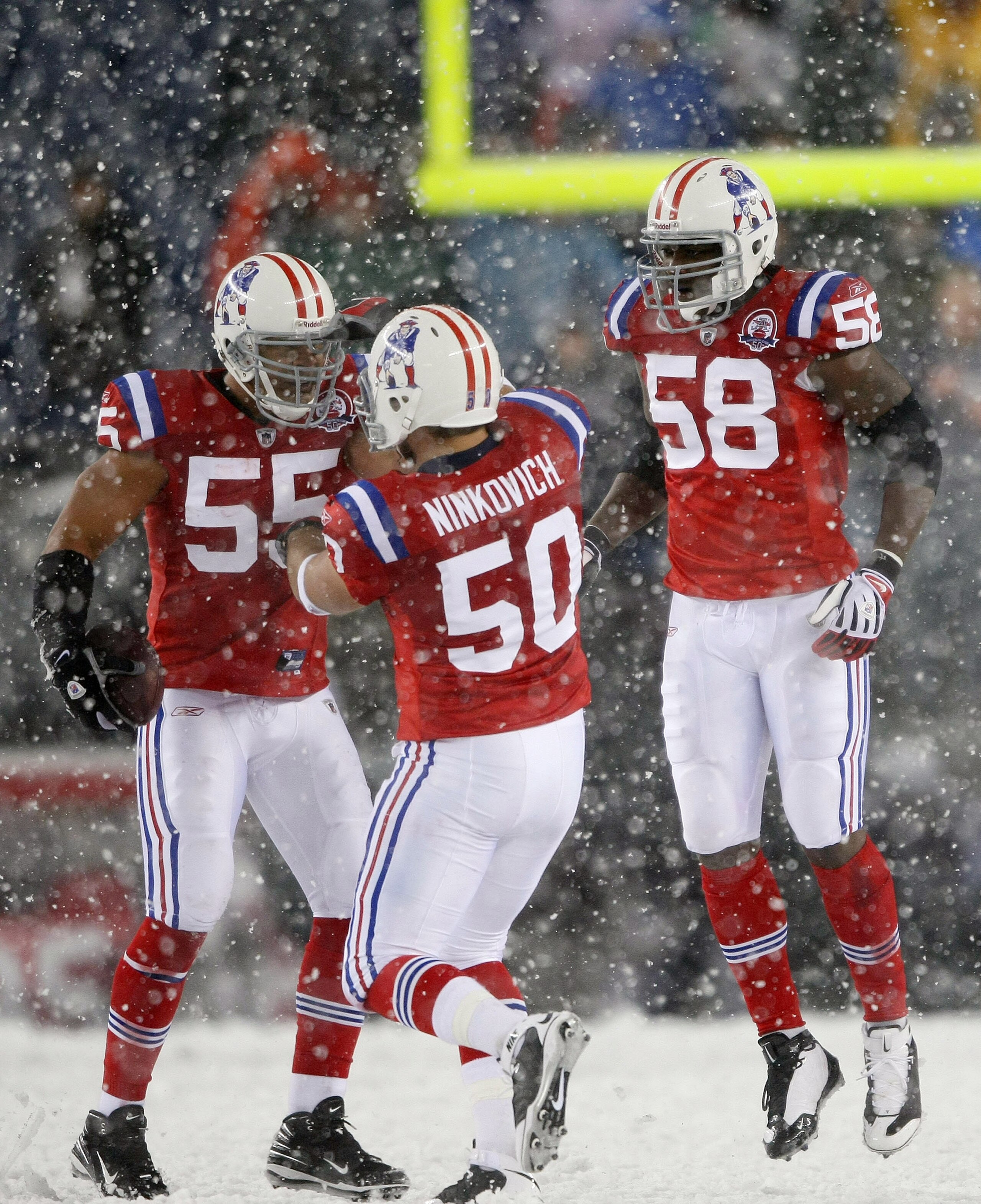 FOXBORO, MA - OCTOBER 18:  Junior Seau #55 of the New England Patriots is congratulated by teammates Rob Ninkovich #50 and Pierre Woods #58 after Seau recovered a fumble by the Tennessee Titans on October 18, 2009 at Gillette Stadium in Foxboro, Massachus