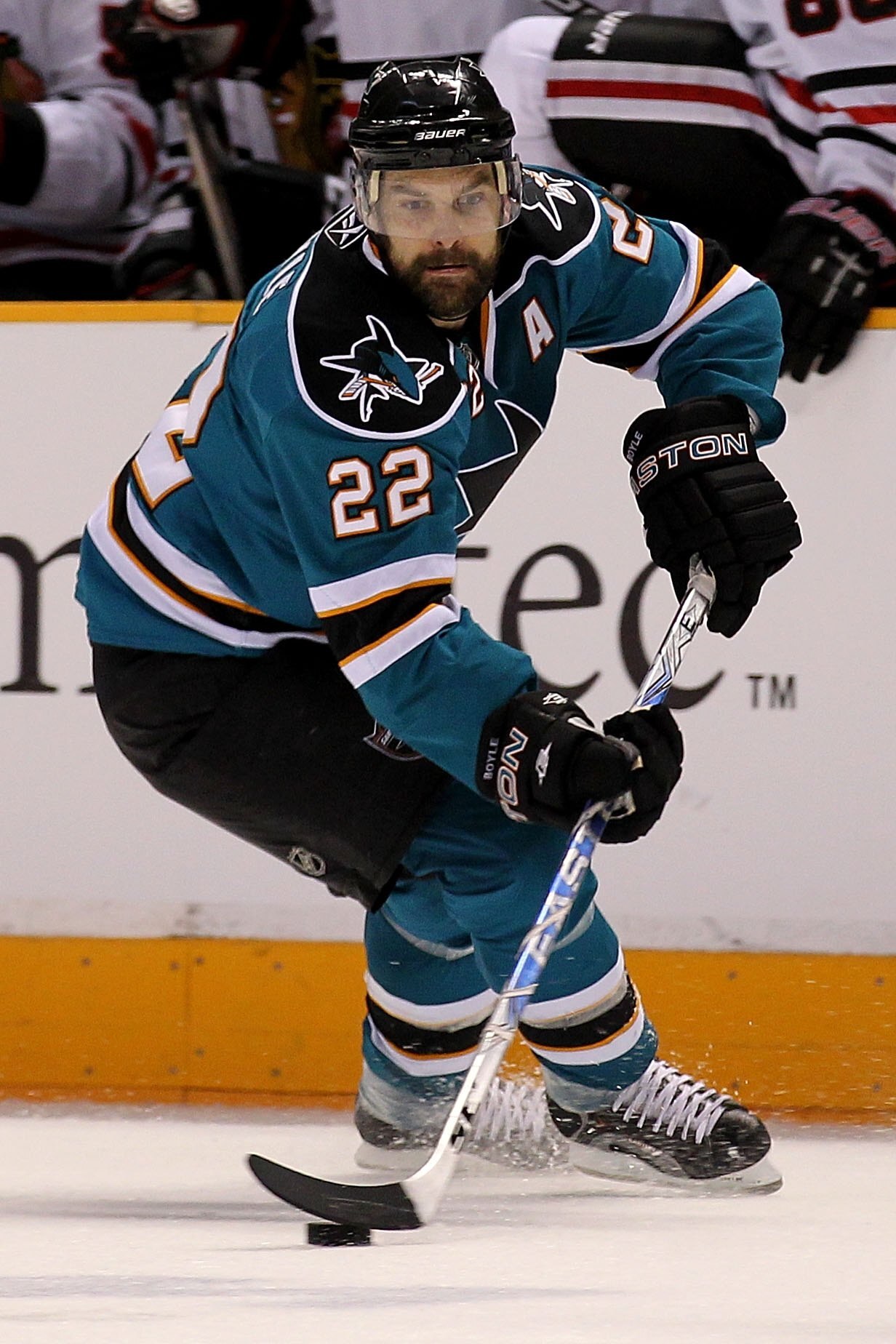SAN JOSE, CA - MAY 18:  Dan Boyle #22 of the San Jose Sharks moves the puck while taking on the Chicago Blackhawks in Game Two of the Western Conference Finals during the 2010 NHL Stanley Cup Playoffs at HP Pavilion on May 18, 2010 in San Jose, California