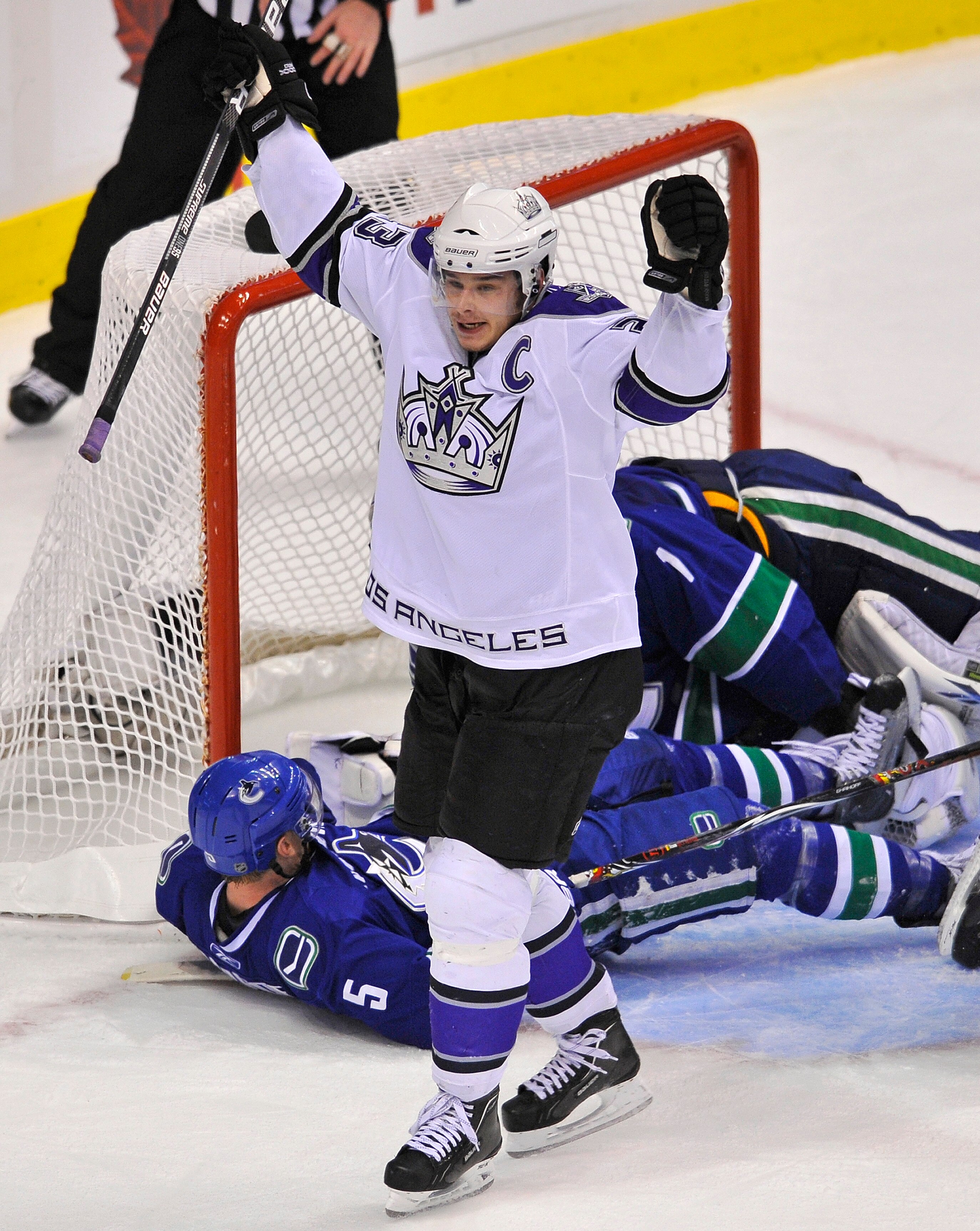 VANCOUVER, CANADA - APRIL 17:  Dustin Brown #23 of the Los Angeles Kings celebrates teammate's Fredrik Modin's #33 (not pictured) goal while Christian Ehrhoff #1 and goalie Roberto Luongo #1 lay on the ice during the second period in Game Two of the Weste