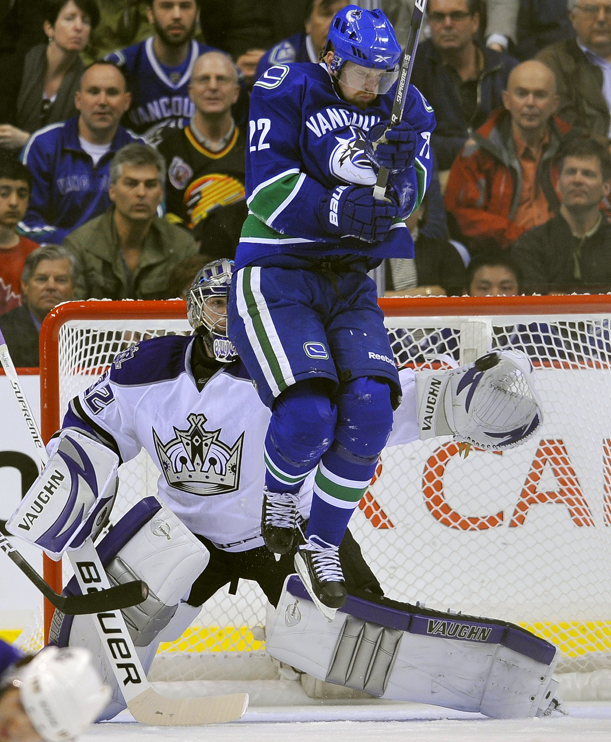 VANCOUVER, CANADA - APRIL 15: Goalie Jonathan Quick #32 of the Los Angeles Kings reaches out to make a glove save while Daniel Sedin #22 of the Vancouver Canucks tries to get out of the way in Game One of the Western Conference Quarterfinals during the 20
