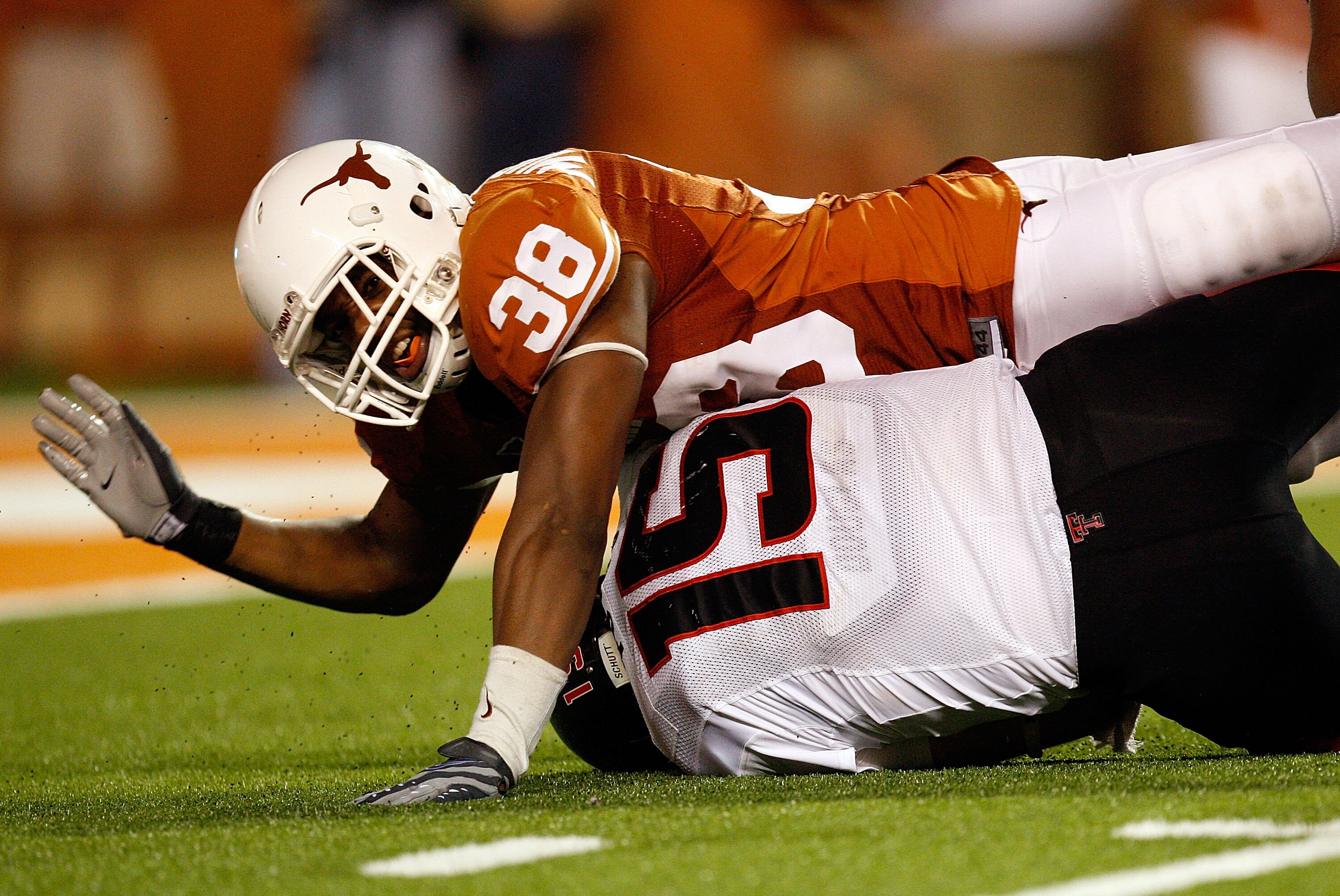 AUSTIN, TX - SEPTEMBER 19:  Quarterback Taylor Potts #15 of the Texas Tech Red Raiders is sacked by Roddrick Muckelroy #38 of the Texas Longhorns at Darrell K Royal-Texas Memorial Stadium on September 19, 2009 in Austin, Texas.  (Photo by Ronald Martinez/