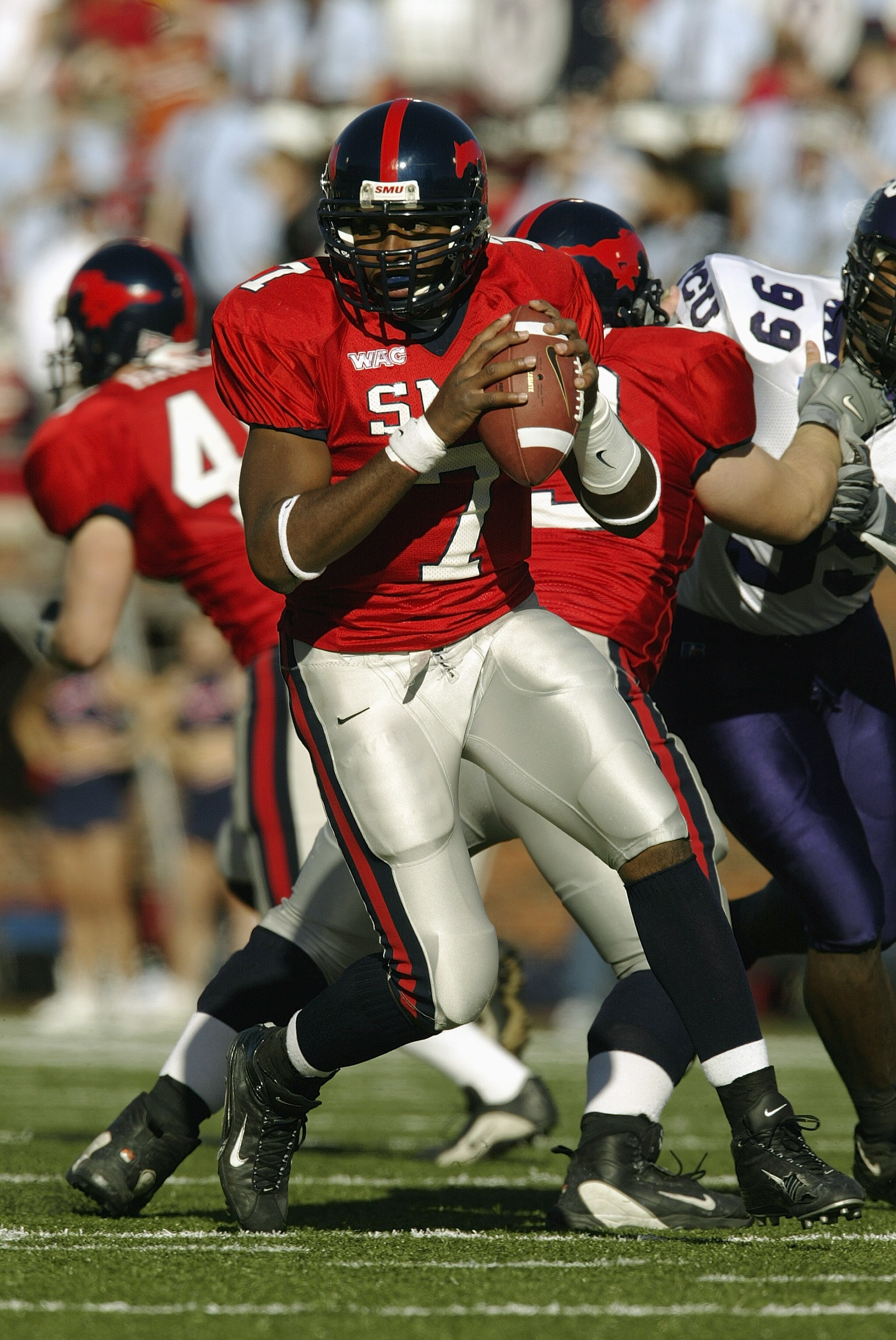 DALLAS - NOVEMBER 29:  Quarterback Chris Phillips #7 of the Southern Methodist University Mustangs runs out of the pocket against the Texas Christian University Horned Frogs on November 29, 2003 at Gerald J. Ford Stadium in Dallas, Texas. TCU won 20-13.  