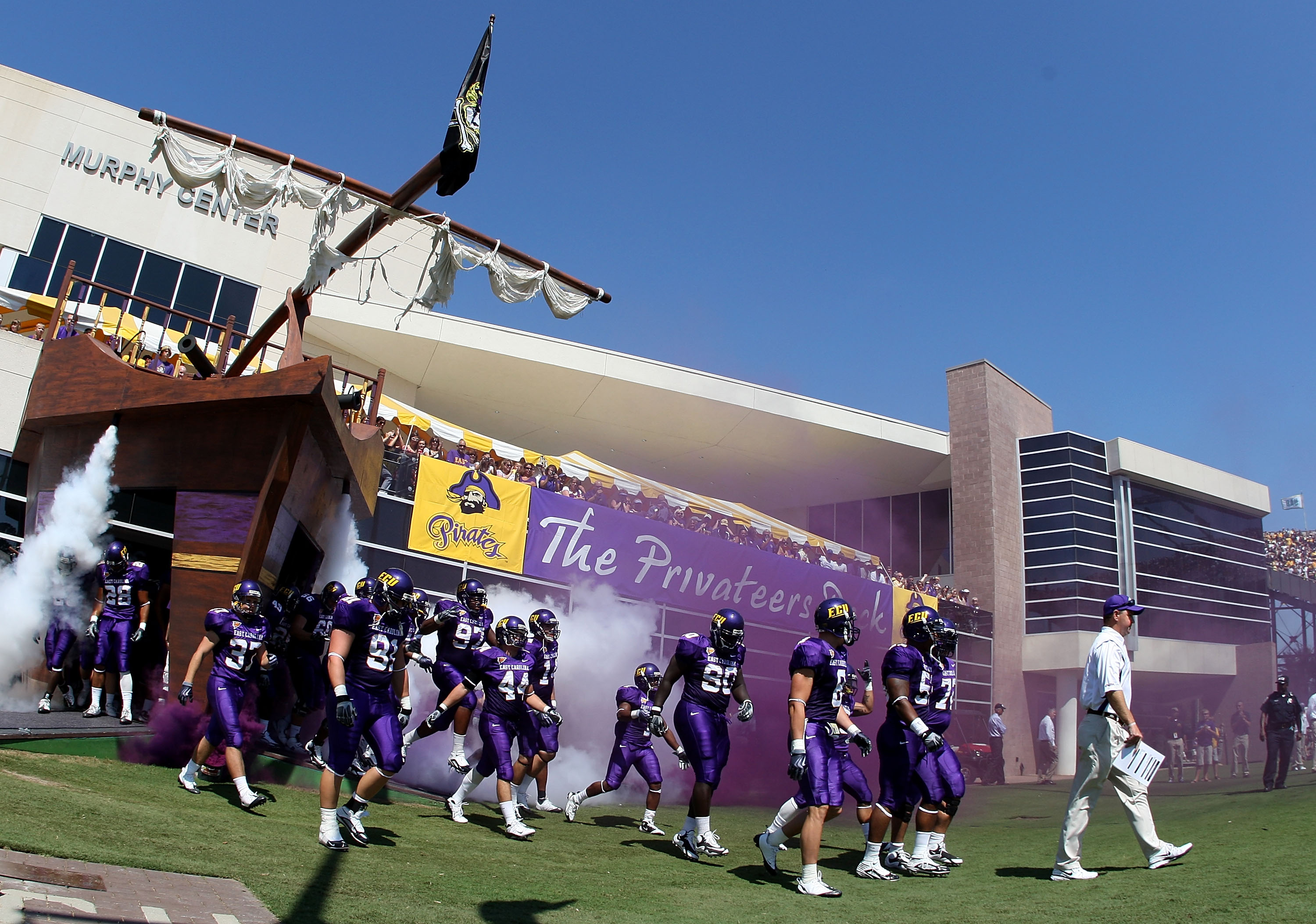GREENVILLE, NC - SEPTEMBER 05:  Head coach Skip Holtz of the East Carolina Pirates walks onto the field with his team before their game against the Appalachian State Mountaineers at Dowdy-Ficklen Stadium on September 5, 2009 in Greenville, North Carolina.