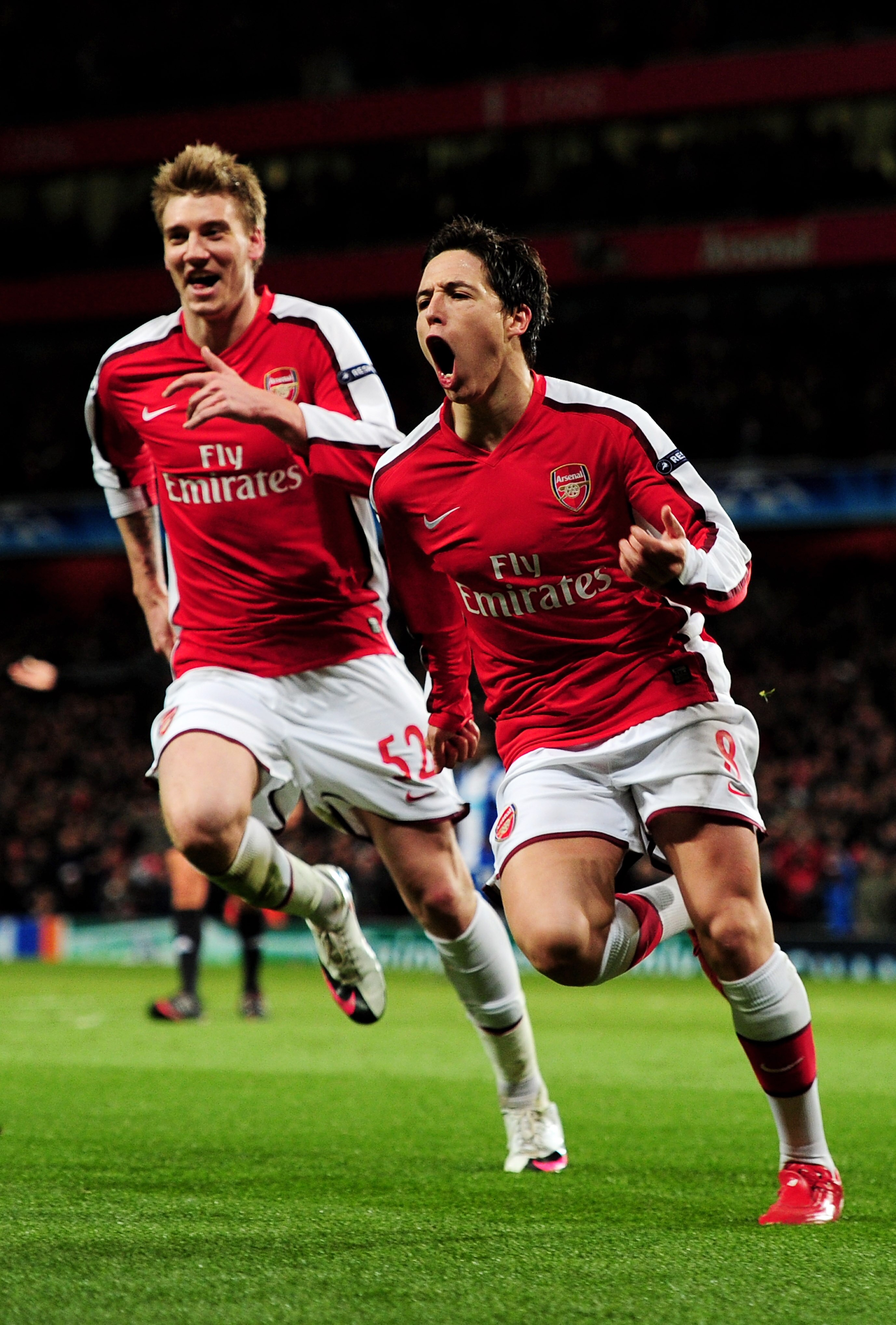 LONDON, ENGLAND - MARCH 09:  Samir Nasri (R) of Arsenal celebrates with teammate Nicklas Bendtner after scoring his team's third goal during the UEFA Champions League round of 16 match between Arsenal and FC Porto at the Emirates Stadium on March 9, 2010