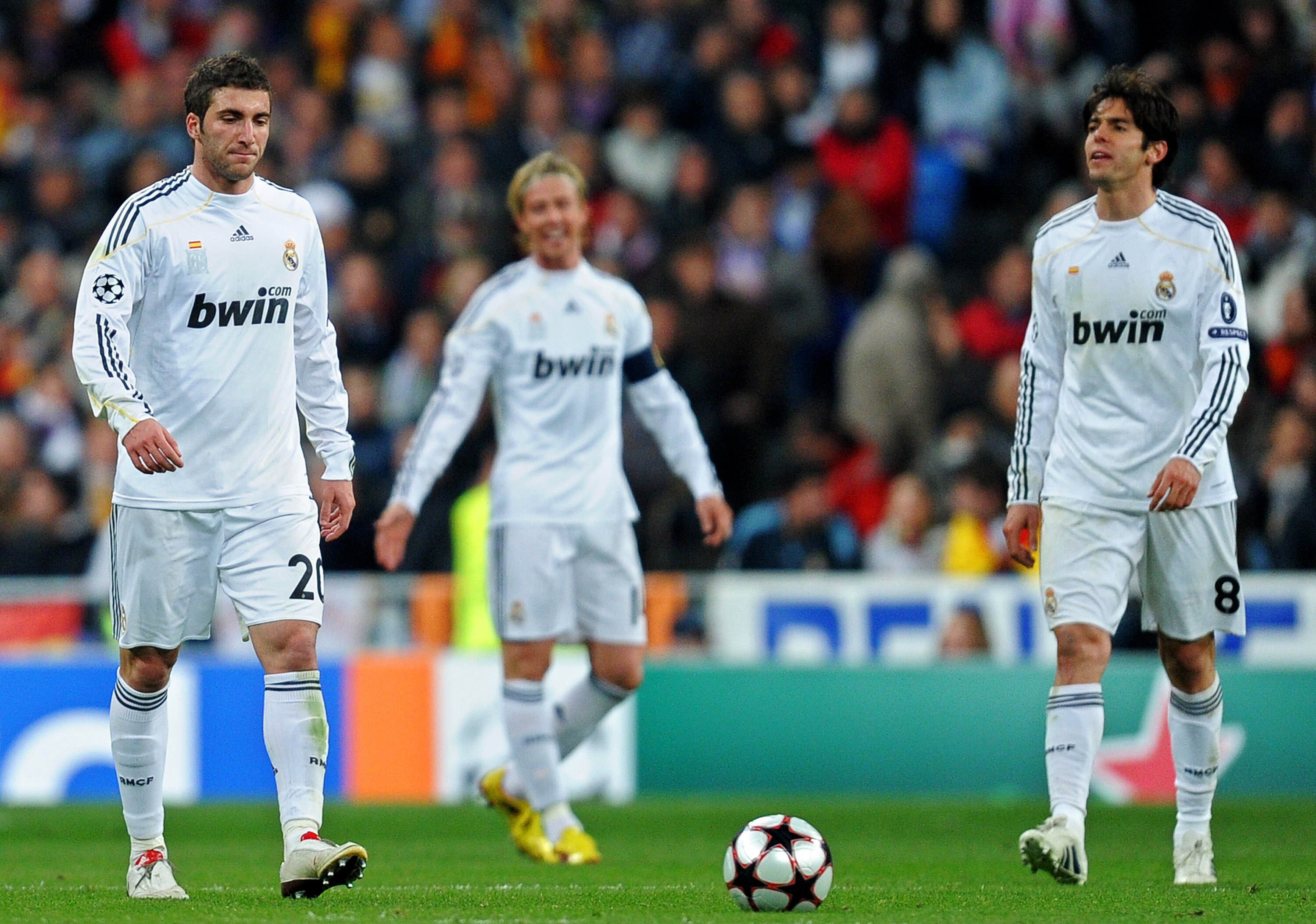 MADRID, SPAIN - MARCH 10:  Gonzalo Higuain (L) of Real Madrid trudges back to the half way line with his team mates Kaka (R) and Jose Maria Gutierrez after conceding a goal during the UEFA Champions League round of 16 second leg match between Real Madrid