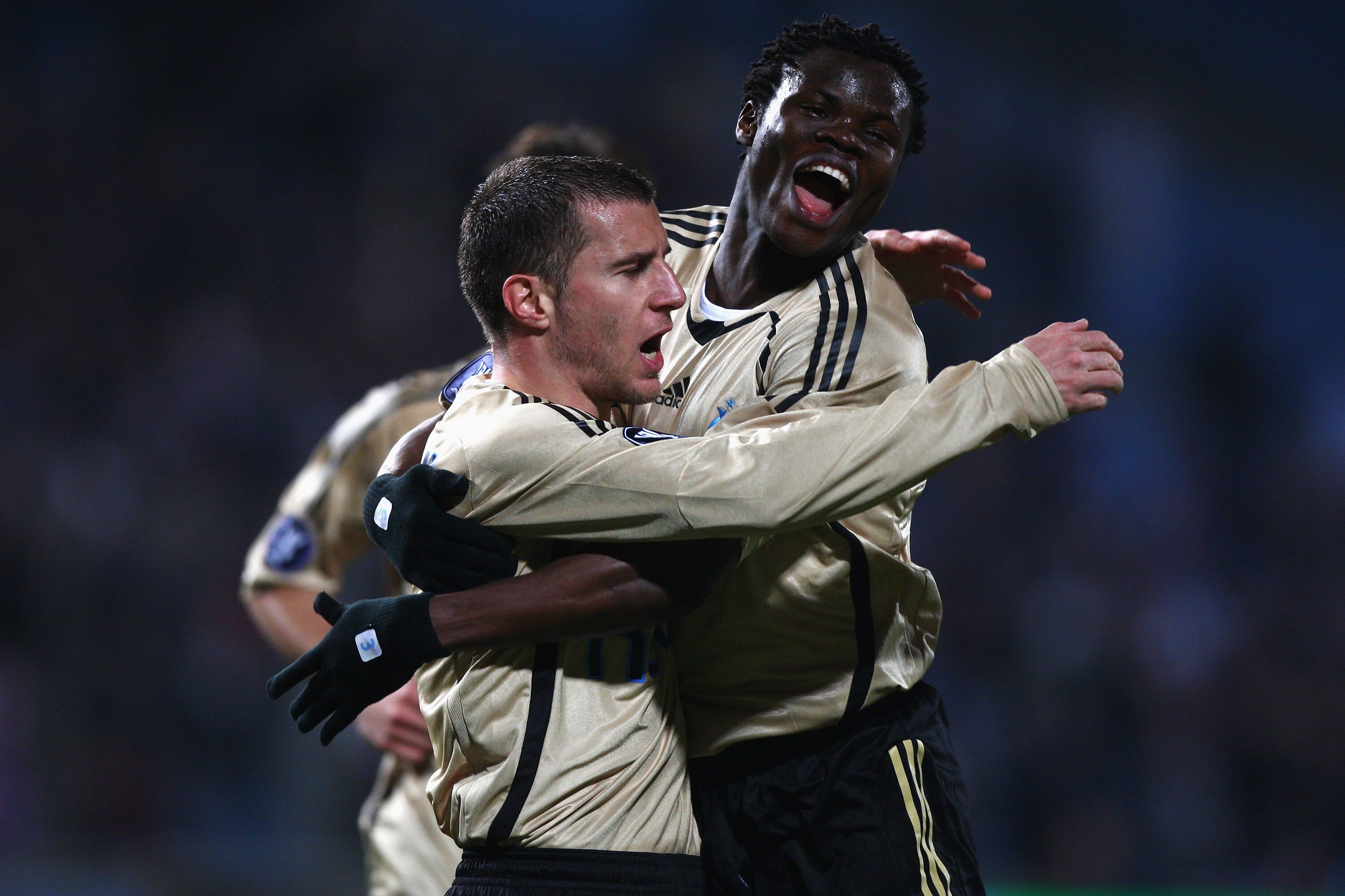 MARSEILLE, FRANCE - MARCH 12: Benoit Cheyrou (L) celebrates scoring the first goal with Ismaila Taiwo Taye (r) during the Uefa Cup last sixteen first leg match between Olympique Marseille and Ajax at the Stade Velodrome on March 12, 2009 in Marseille,Fran