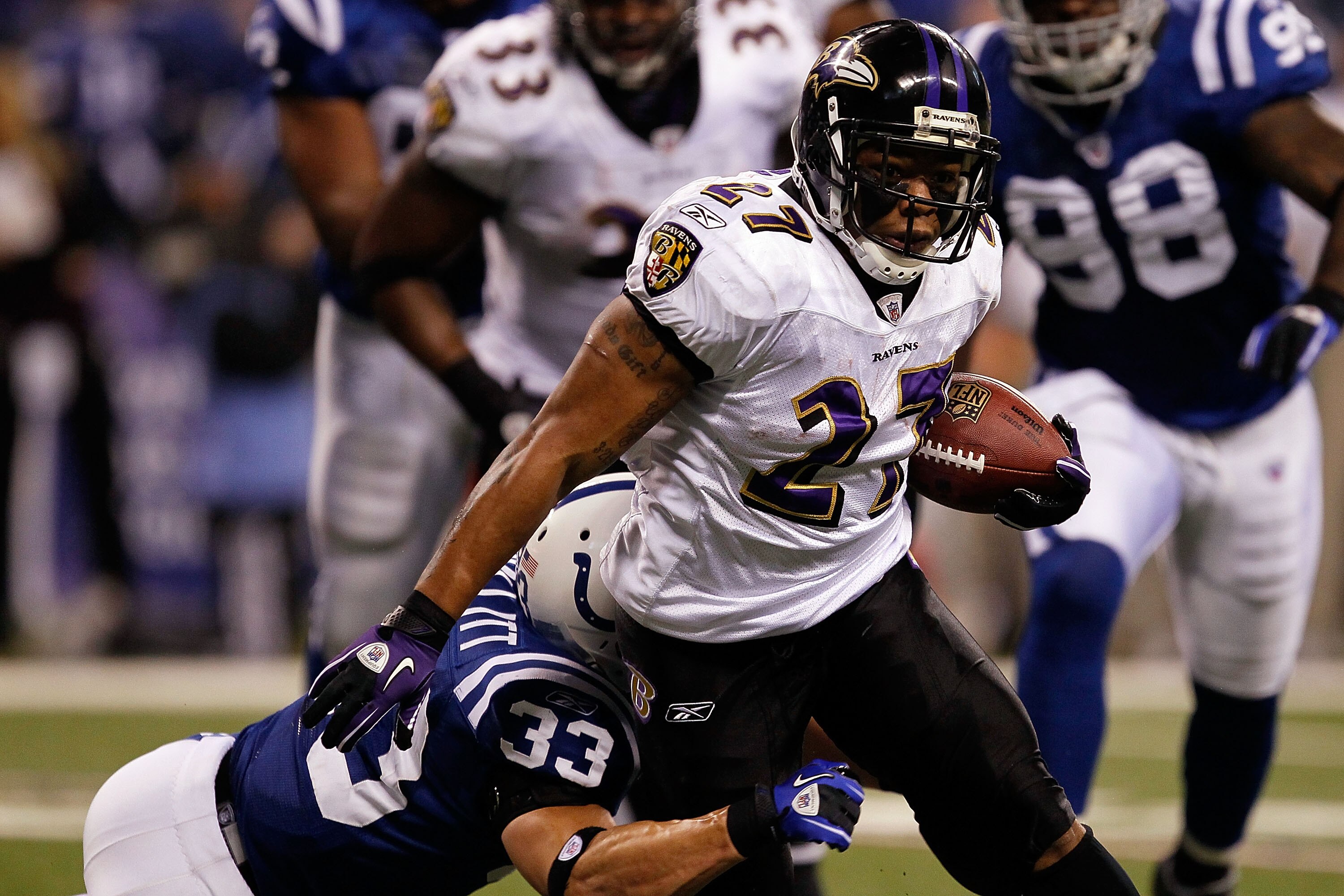 INDIANAPOLIS - JANUARY 16:  Ray Rice #27 of the Baltimore Ravens runs the ball as Melvin Bullitt #33 of the Indianapolis Colts looks to tackle him in the first quarter of the AFC Divisional Playoff Game at Lucas Oli Stadium on January 16, 2010 in Indianap