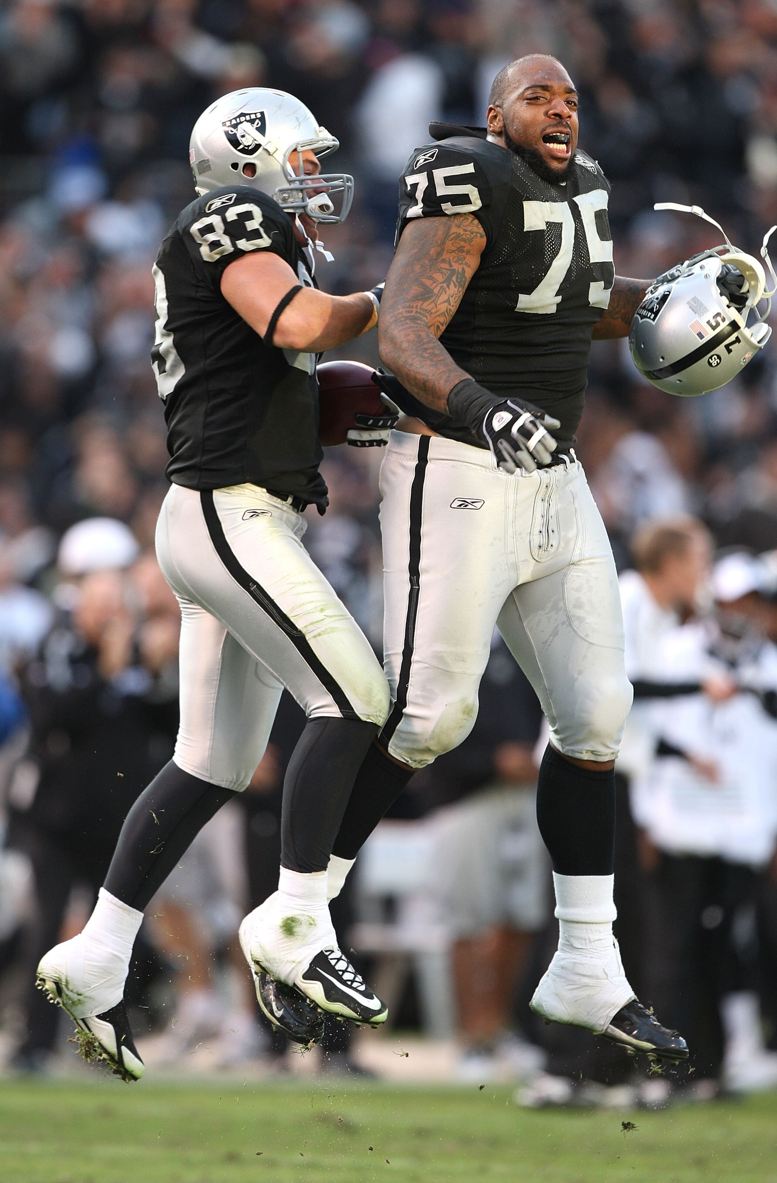 OAKLAND, CA - NOVEMBER 22:  Brandon Myers #83 of the Oakland Raiders celebrates with Mario Henderson #75 after defeating the Cincinnati Bengals during an NFL game at Oakland-Alameda County Coliseum on November 22, 2009 in Oakland, California.  (Photo by J