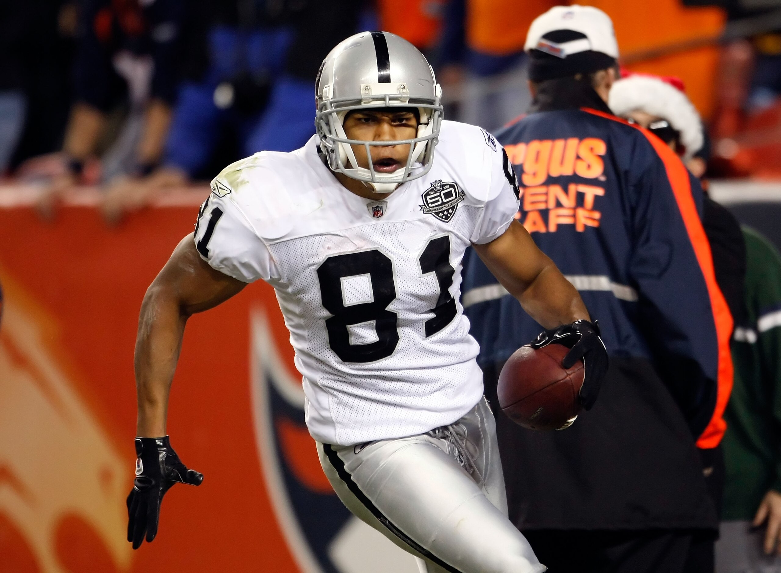 DENVER - DECEMBER 20:  Chaz Schilens #81 of the Oakland Raiders celebrates after scoring a touchdown late in the fourth quarter against the Denver Broncos at Invesco Field at Mile High on December 20, 2009 in Denver, Colorado. The Raiders defeated the Bro