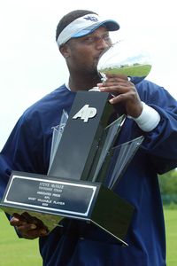 The late Steve McNair kissing his MVP trophy.