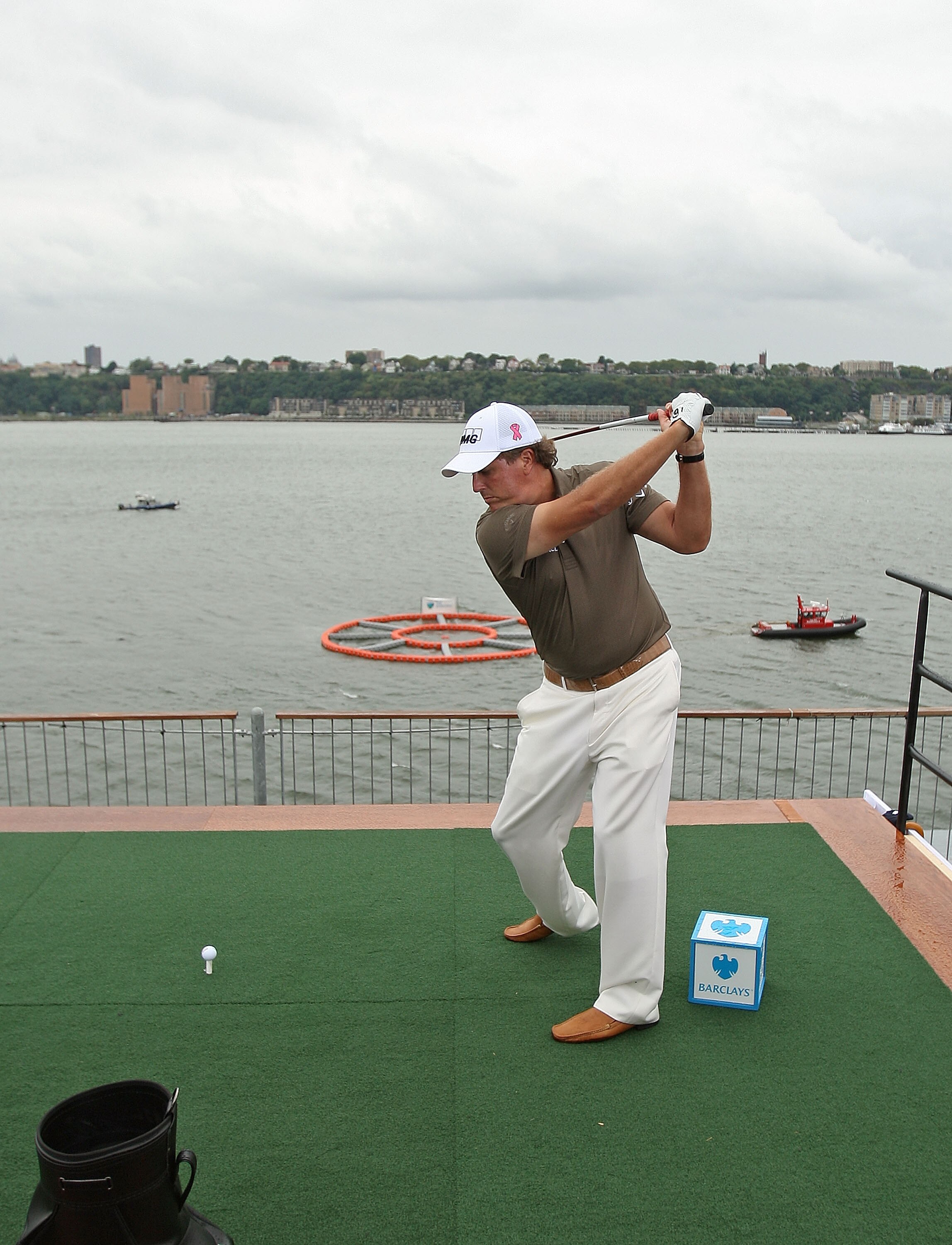 NEW YORK - AUGUST 24:  Phil Mickelson hits balls into a target in the Hudson River for the Chips for Charity event at Intrepid Aircraft Carrier on August 24, 2010 in New York City.  (Photo by Mike Ehrmann/Getty Images)