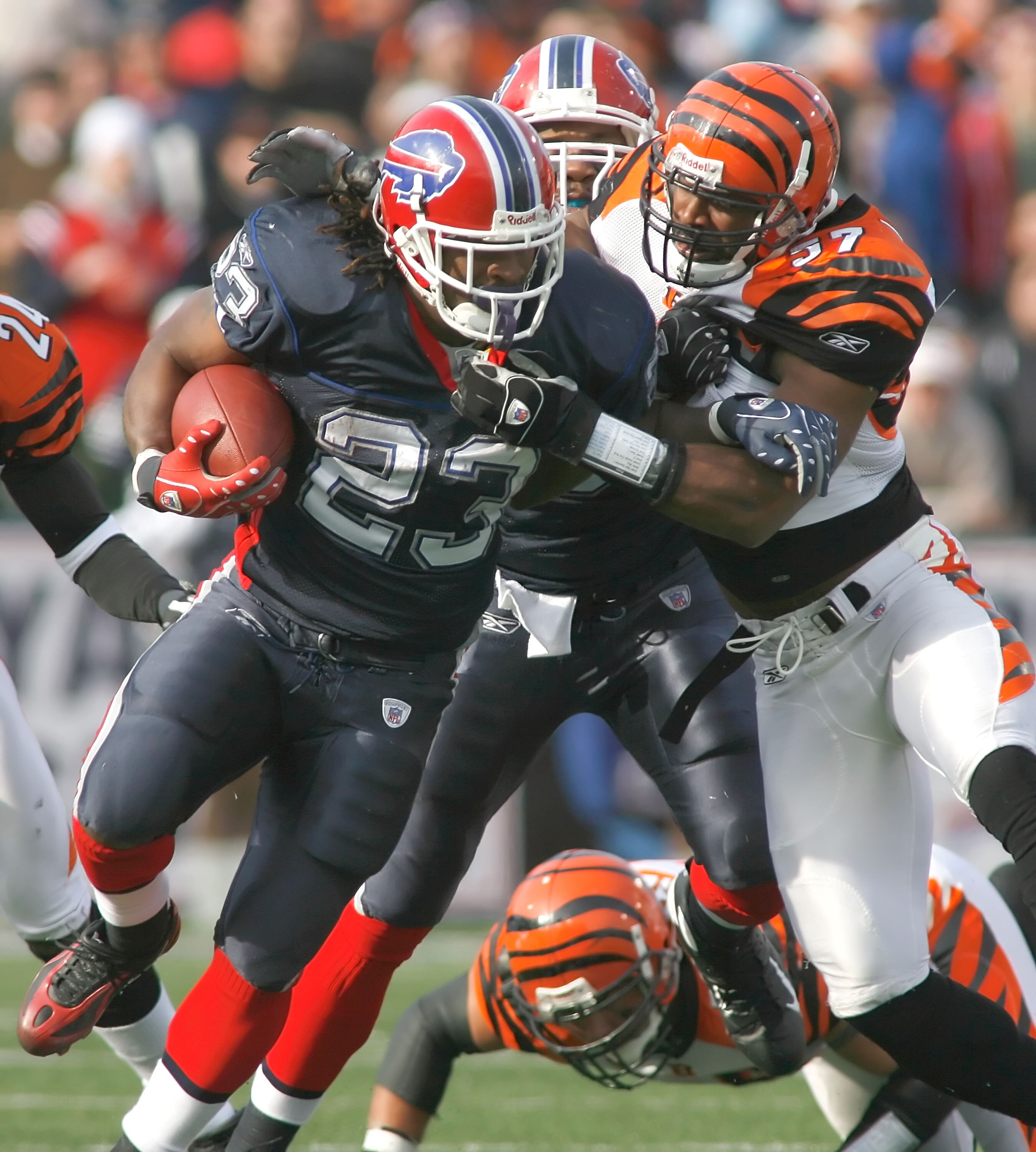 ORCHARD PARK, NY - NOVEMBER 04: Marshawn Lynch #23 of the Buffalo Bills runs as Dhani Jones #57 of the Cincinnati Bengals comes in to make the tackle on November 4, 2007 at Ralph Wilson Stadium in Orchard Park, New York. Buffalo won 33-21. (Photo by Rick 