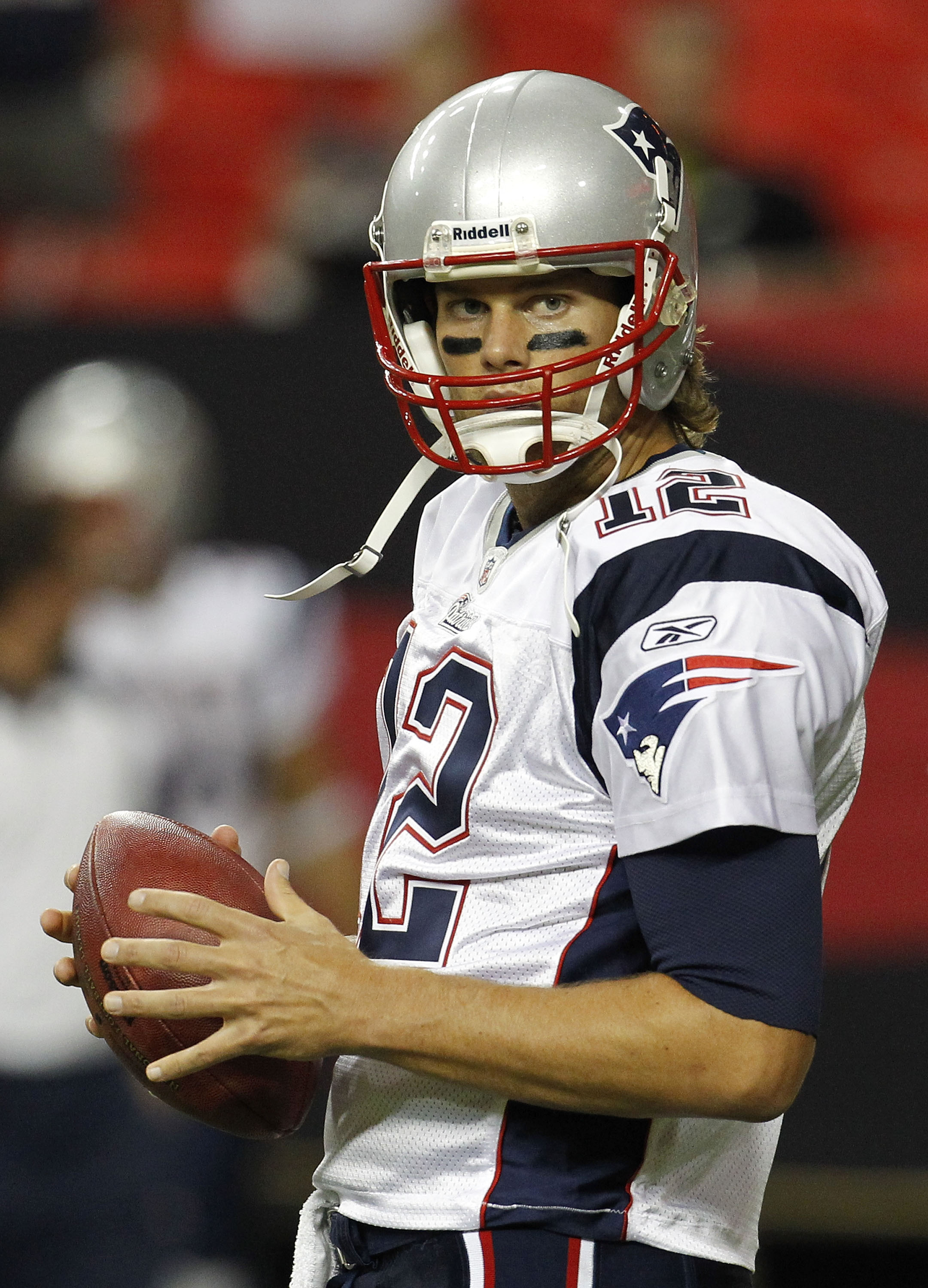 ATLANTA - AUGUST 19:  Quarterback Tom Brady #12 of the New England Patriots takes a break during pre-game drills before the preseason game against the Atlanta Falcons at the Georgia Dome on August 19, 2010 in Atlanta, Georgia.  (Photo by Mike Zarrilli/Get