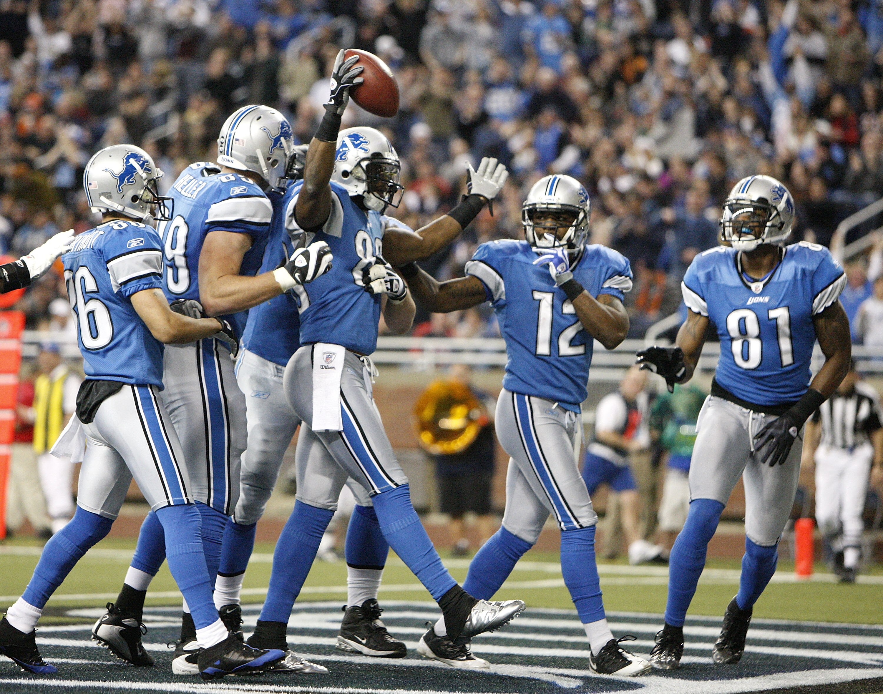 DETROIT - JANUARY 03: Bryant Johnson #80 of the Detroit Lions celebrates a second quarter touchdown with Calvin Johnson #81 and Derrick Williams #12 while playing the Chicago Bears on January 3, 2010 at Ford Field in Detroit, Michigan.  (Photo by Gregory 
