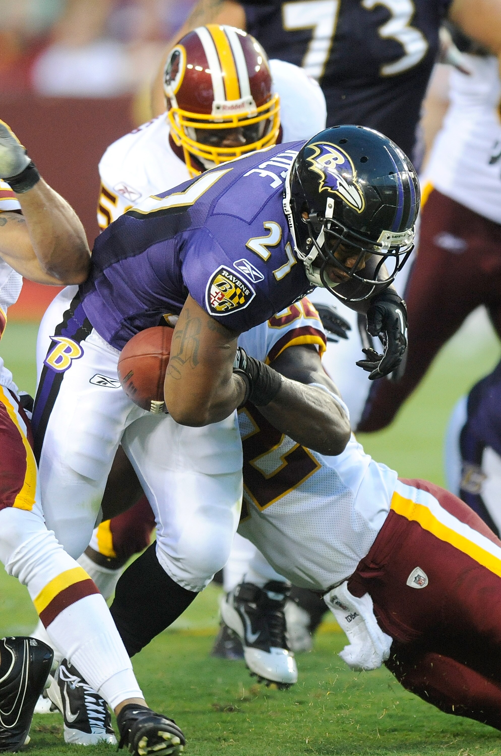 LANDOVER, MD - AUGUST 21:  Ray Rice #27 of the Baltimore Ravens fumbles the ball during the preseason game after a hit by Rocky McIntosh #52 of the Washington Redskins at FedExField on August 21, 2010 in Landover, Maryland.  (Photo by Greg Fiume/Getty Ima