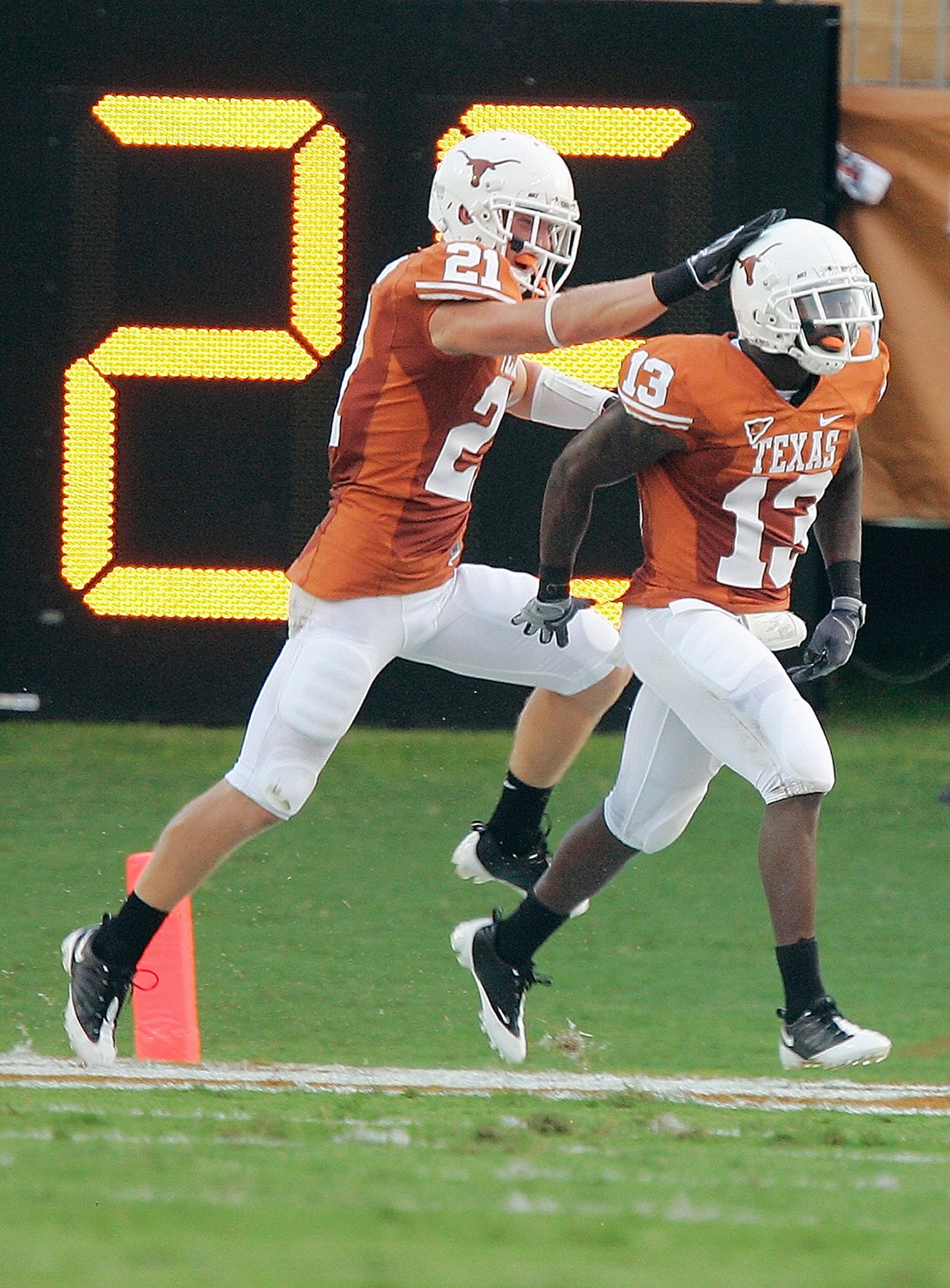 AUSTIN, TX - AUGUST 30: Ryan Palmer #13 of the Texas Longhorns is congratulated by  Blake Gideon #21 during the game against the Florida Atlantic Owls on August 30, 2007 at Darrell K Royal-Texas Memorial Stadium in Austin, Texas.  Texas won 52-10. (Photo
